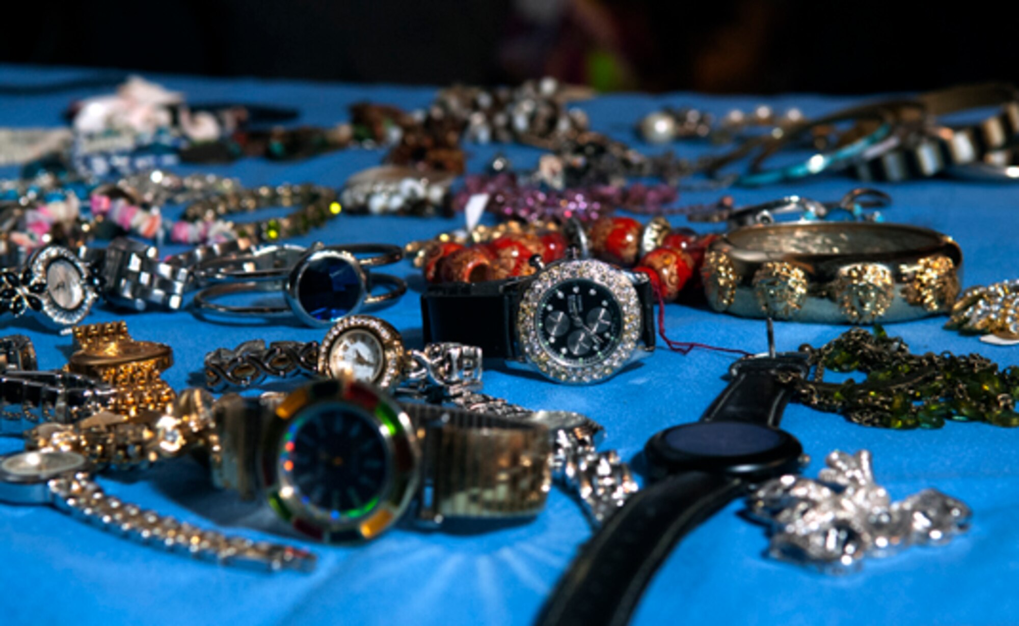 Watches and other baubles are displayed for sale by Staff Sgt. Charles Hill, 90th Munitions Squadron, and his wife Gayle Hill at their booth in Fall Hall Community Center for the flea market sponsored by the 90th Force Support Squadron March 3. (U.S. Air Force photo by R.J. Oriez)