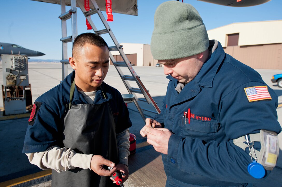 Staff Sgt. John Bellardino (right), and Senior Airman David Ching, 28th Aircraft Maintenance Squadron aircraft systems specialists, inspect parts removed from a B-1B at Ellsworth Air Force Base, S.D., March 8, 2012. Aircraft systems specialists diagnose fuel system and component malfunctions, recommend corrective actions, and resolve functional problems. (U.S. Air Force photo by Airman 1st Class Zachary Hada/Released)