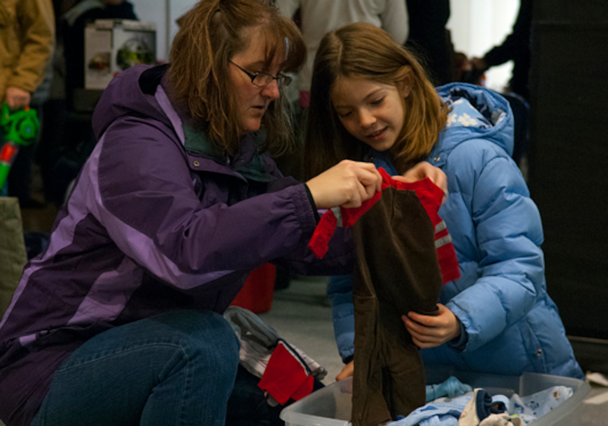 Christy Waldo, and her daughter Abbie, 10, look through toddler clothing at a flea market held in Fall Hall Community Center March 3. Christy Waldo is the wife of Senior Master Sgt. Robert Waldo, 90th Munitions Squadron. (U.S. Air Force photo by R.J. Oriez)