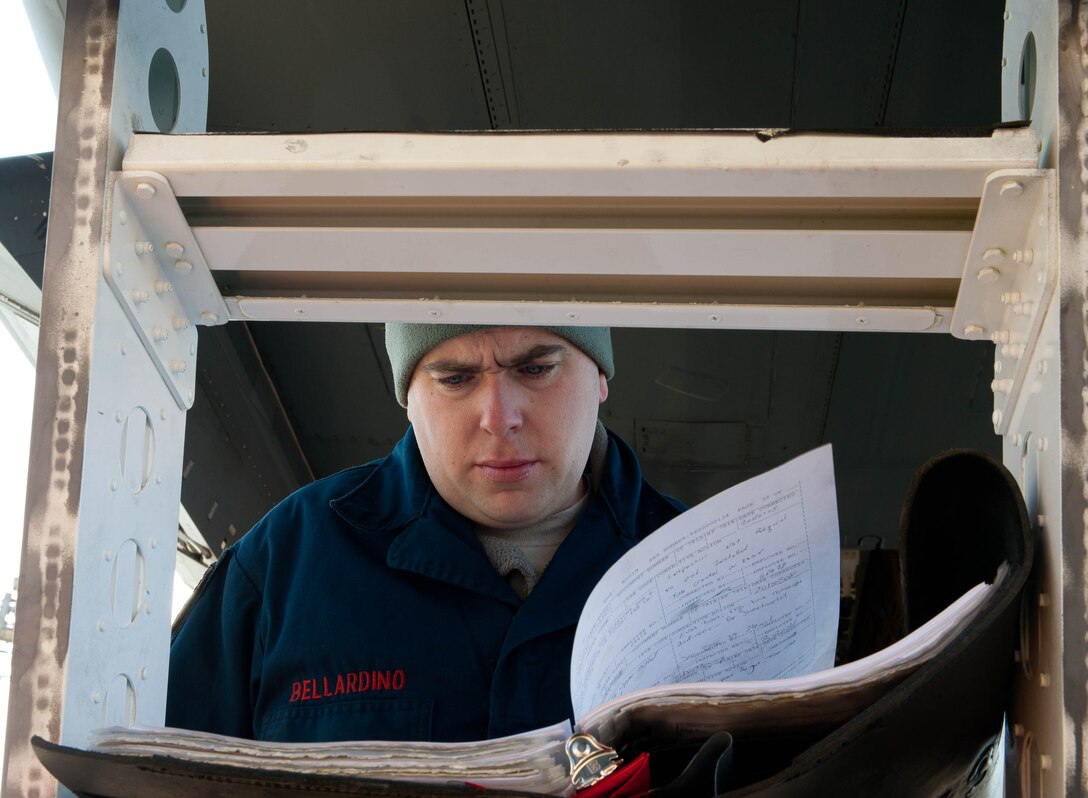 Staff Sgt. John Bellardino, 28th Aircraft Maintenance Squadron aircraft systems craftsman, reviews technical data, work orders and aircraft maintenance procedures on the flightline at Ellsworth Air Force Base, S.D., March 8, 2012. Aircraft systems specialists are responsible for maintaining and troubleshooting internal hardware such as valves, lines, controls and other attachments to ensure aircraft remain operational. (U.S. Air Force photo by Airman 1st Class Zachary Hada/Released)