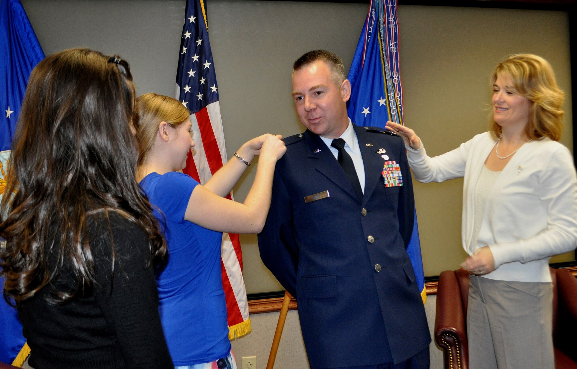 TRAVIS AIR FORCE BASE, Calif. -- Col. Carl L. Reed II is all smiles after his promotion ceremony Mar. 1, 2012. Family and friends at the Reserve's 349th Air Mobility Wing celebrated with him as he pinned on his eagles. Pictured from the left: daughers Sarah and Olivia, Col. Reed, and his wife, Simone. (U.S. Air Force photo/Senior Master Sgt. Ellen L. Hatfield)