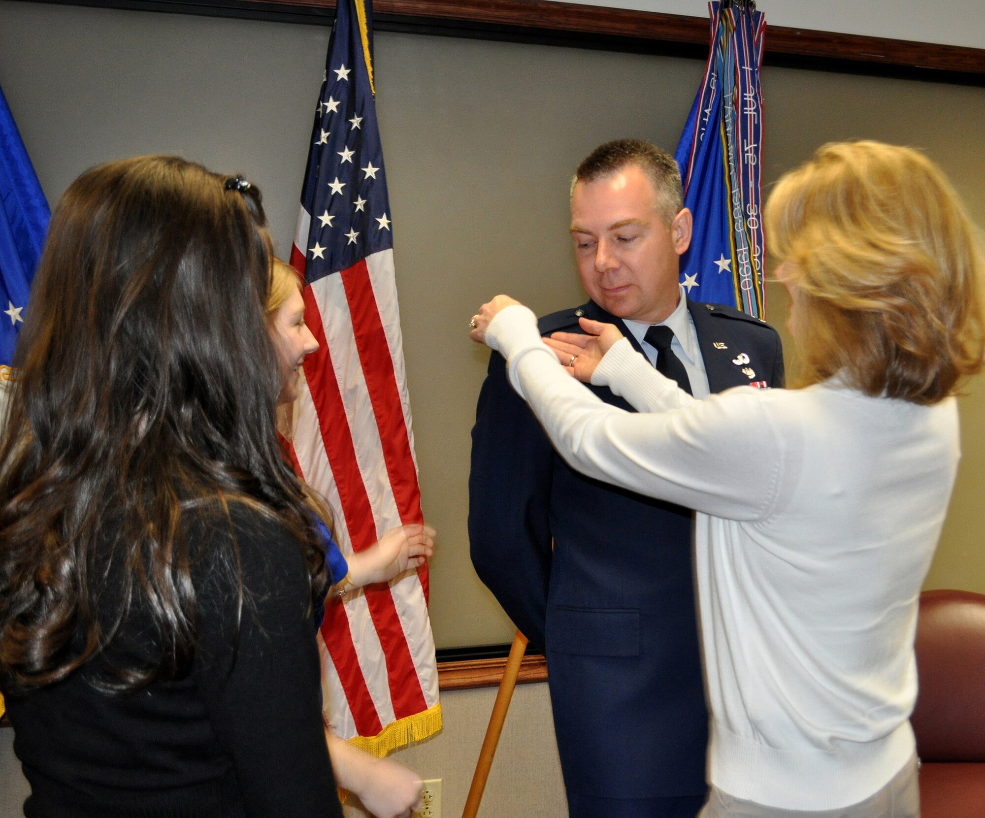 TRAVIS AIR FORCE BASE, Calif. -- Col. Carl L. Reed II is all smiles after his promotion ceremony Mar. 1, 2012. Family and friends at the Reserve's 349th Air Mobility Wing celebrated with him as he pinned on his eagles. Pictured from the left: daughers Sarah and Olivia, Col. Reed, and his wife, Simone. (U.S. Air Force photo/Senior Master Sgt. Ellen L. Hatfield)