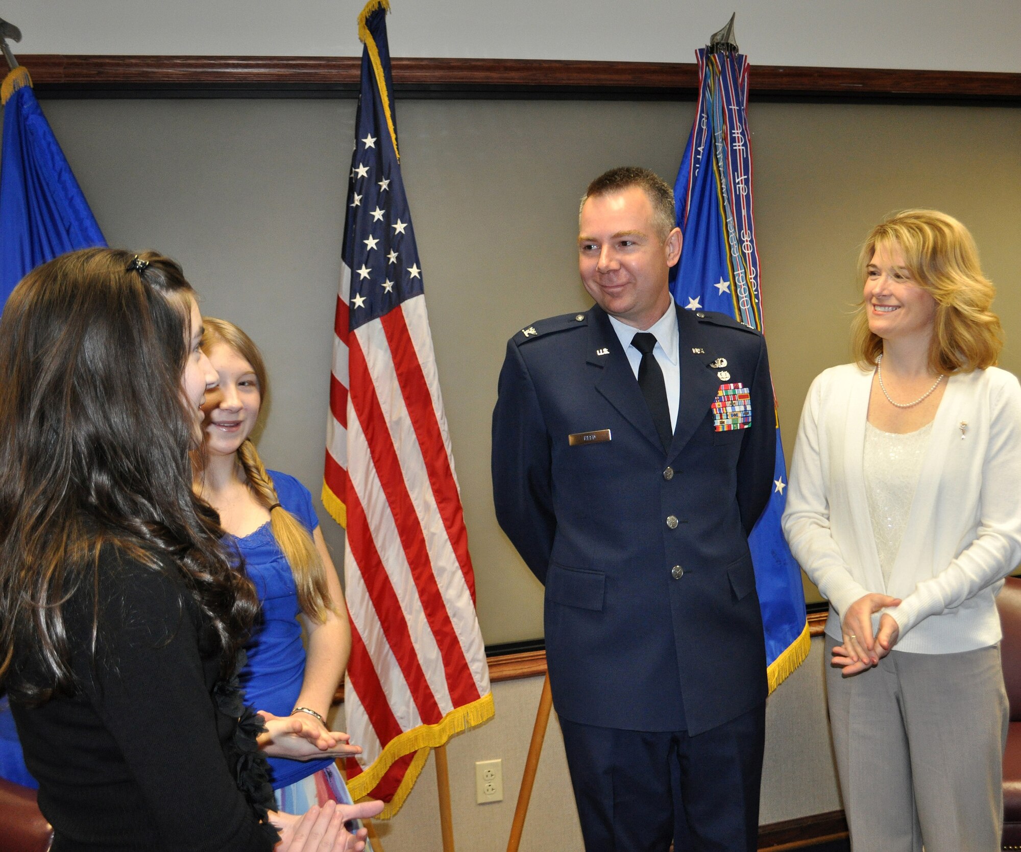 TRAVIS AIR FORCE BASE, Calif. -- Col. Carl L. Reed II is all smiles after his promotion ceremony Mar. 1, 2012. Family and friends at the Reserve's 349th Air Mobility Wing celebrated with him as he pinned on his eagles. Pictured from the left: daughers Sarah and Olivia, Col. Reed, and his wife, Simone. (U.S. Air Force photo/Senior Master Sgt. Ellen L. Hatfield)