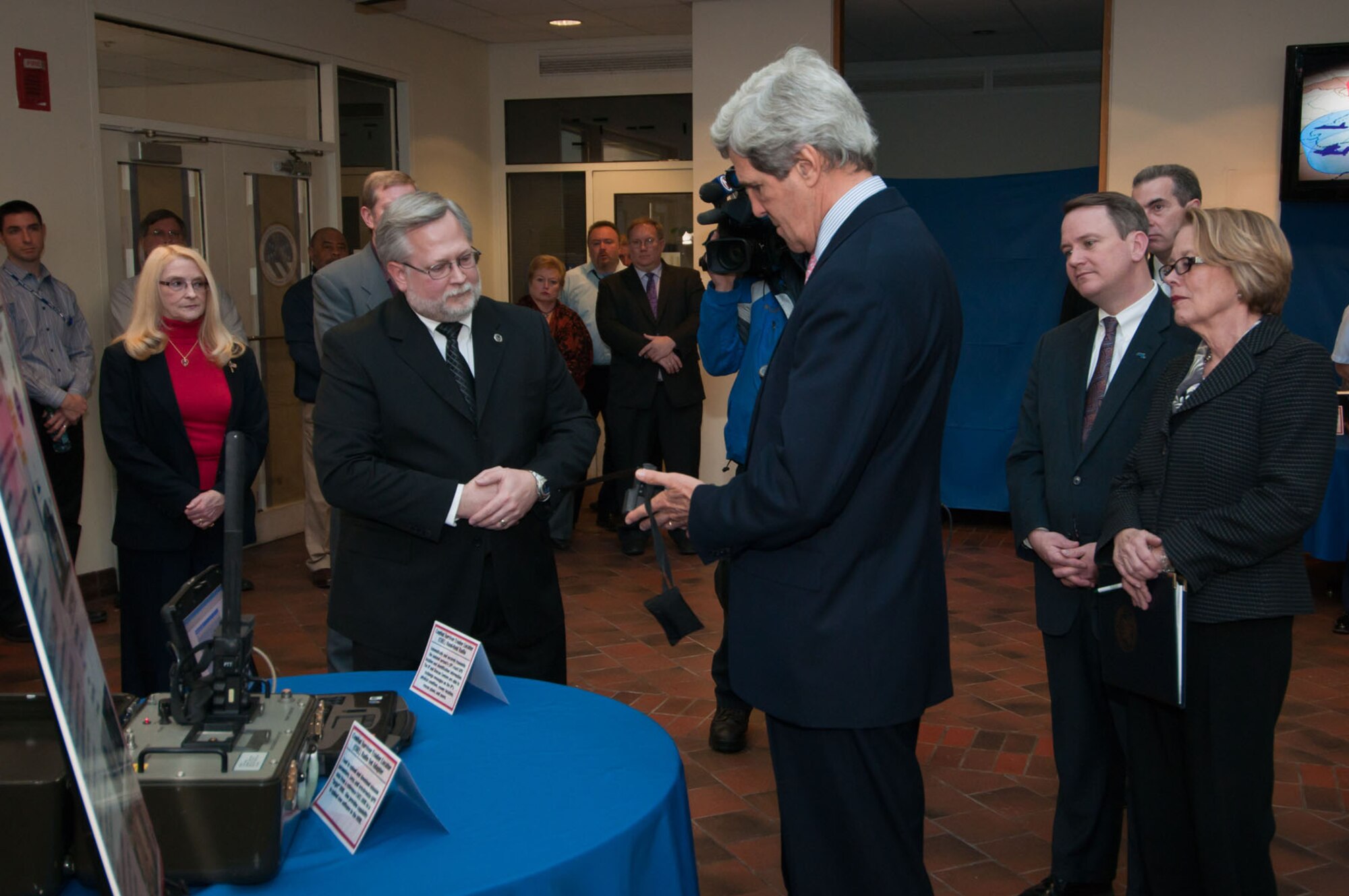 HANSCOM AIR FORCE BASE, Mass. - Ken Reynolds, Combat Survivor Evader Locator deputy program manager, discusses the CSEL program with U.S. Sen. John Kerry (middle) while U.S. Rep. Niki Tsongas (right) and Massachusetts Lt. Gov. Tim Murray look on. The state leaders visited Hanscom March 5 to learn more about the mission performed here. (U.S. Air Force photo by Rick Berry)