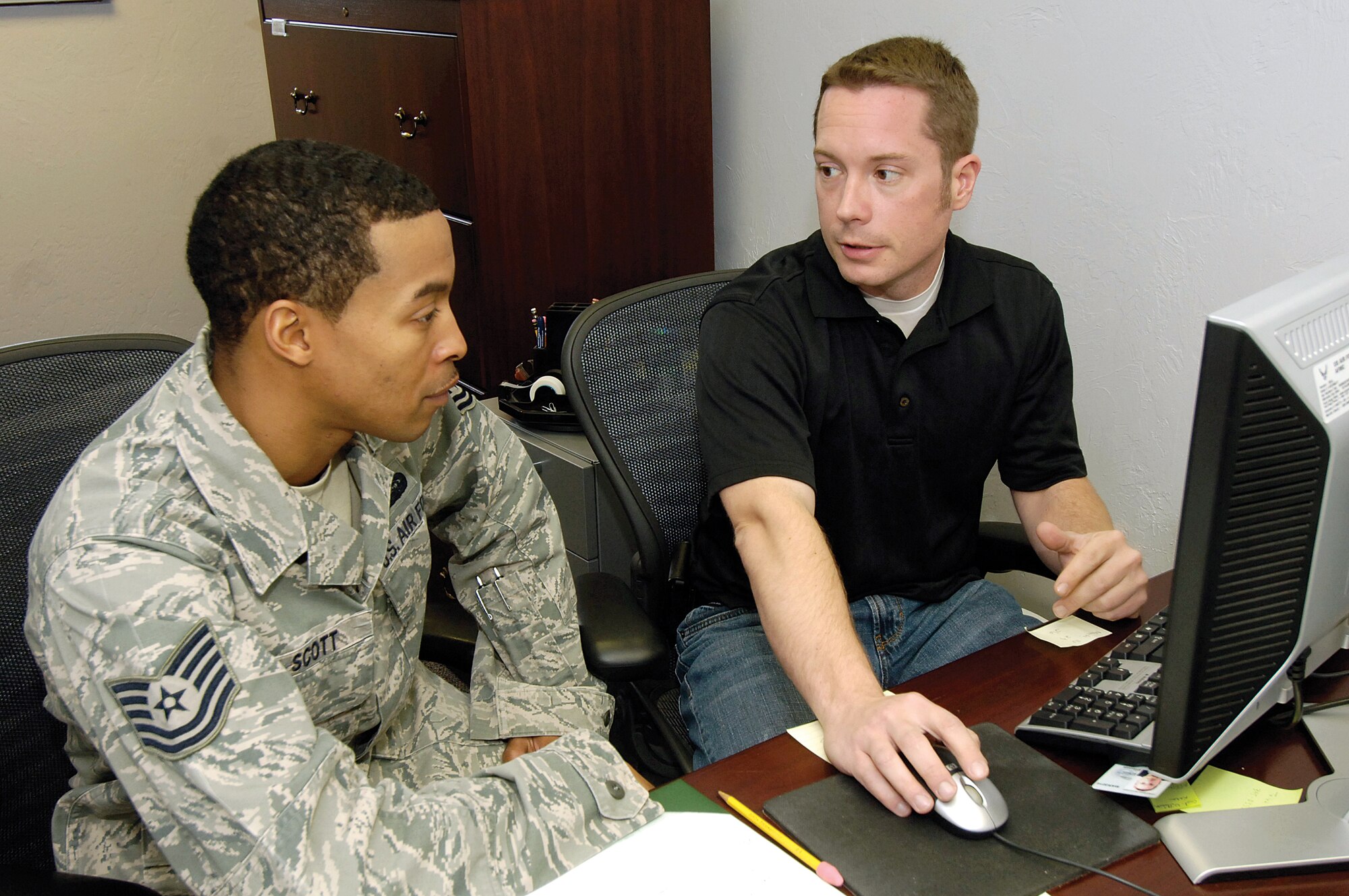 Navigating the steps for a military move is now an easier and quicker journey thanks to a recent rapid-improvement event held by Tinker’s Personal Property Office. At the 72nd Logistics Readiness Squadron office in Bldg. 5803, Tech. Sgt. Nicholas Scott of the 31st Combat Communications Squadron, works with PPO transportation assistant Chris Fellows in preparing for his move to Korea. The RIE helped the PPO identify ways to cut time and frustration from the process and gave customers more control over filling out their paperwork. (Air Force photo by Margo Wright)