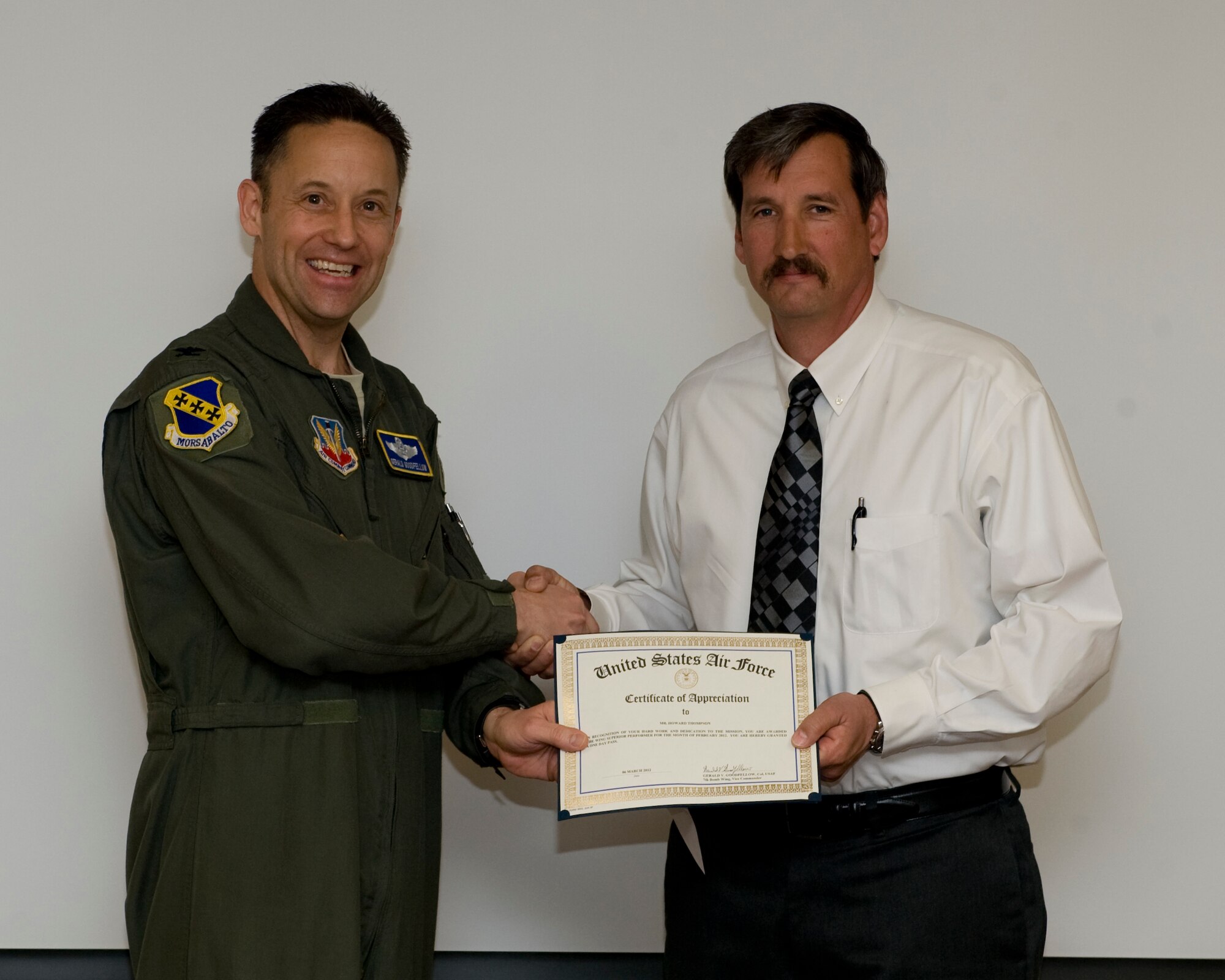 U.S. Air Force Col. Gerald Goodfellow, 7th Bomb Wing vice commander, presents Howard Thompson, 7th BW, with the February wing staff agencies superior performer award, March 8, 2012 at Dyess Air Force Base, Texas. Every month each group selects a person or team who has shown superior performance to be recognized in front of wing leadership. (U.S. Air Force photo by Airman 1st Class Jonathan Stefanko/ Released)