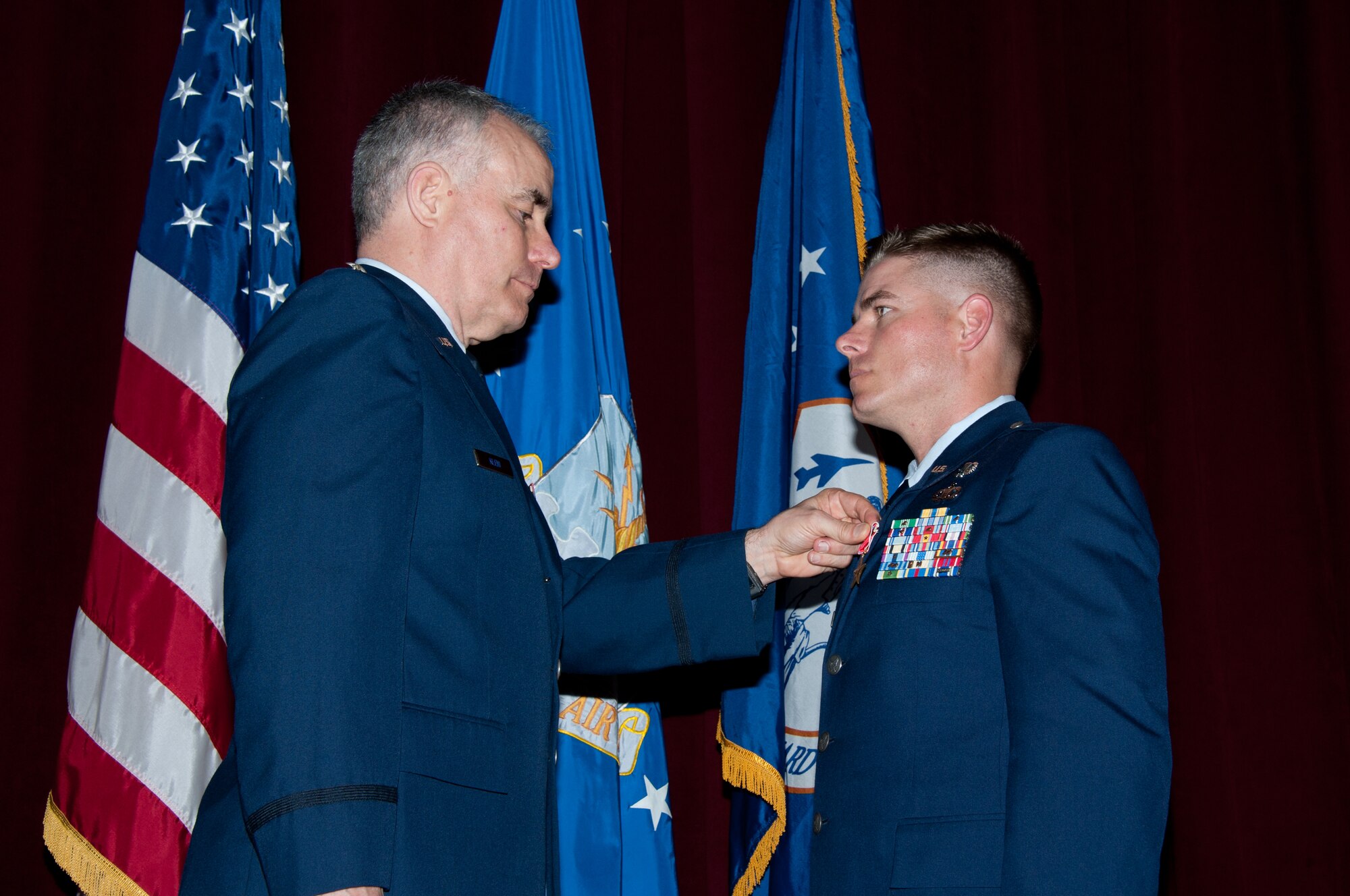 Lt. Col. Kenneth Kleid, acting commander of the Oklahoma Air National Guard's 146th Air Support Operations Squadron, presents the Bronze Star Medal to 2nd Lt. Christopher Schutte of Las Vegas, Nev., an air liaison officer for the 146th ASOS, at Officer Training School March 1. Schutte, who earned his commission as a second lieutenant in the Oklahoma Air National Guard from the Academy of Military Science March 2 , is the first OTS student to receive a Bronze Star Medal during his commissioning training. Schutte earned the medal for actions he took while serving as the enlisted battalion air liaison officer and lead joint terminal attack controller in support of the 1st Battalion, 179th Regiment, 45th Infantry Brigade Combat Team. He and his team engaged in ground combat in the Laghman and Nuristan Provinces, Regional Command-East, Afghanistan, during Operation Enduring Freedom from July 13 to Dec. 12, 2011. (Air Force photo/Melanie Rodgers Cox)