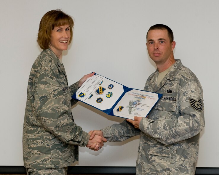 U.S. Air Force Col. Kristina O’Brien, 7th Mission Support Group commander, presents Tech. Sgt. Benjamin Lincecum, 7th Logistics Readiness Squadron, with the February 7th MSG superior performer award, March 8,2012, at Dyess Air Force Base, Texas. Every month each group selects a person or team who has shown superior performance to be recognized in front of wing leadership. (U.S. Air Force photo by Airman 1st Class Jonathan Stefanko/ Released)