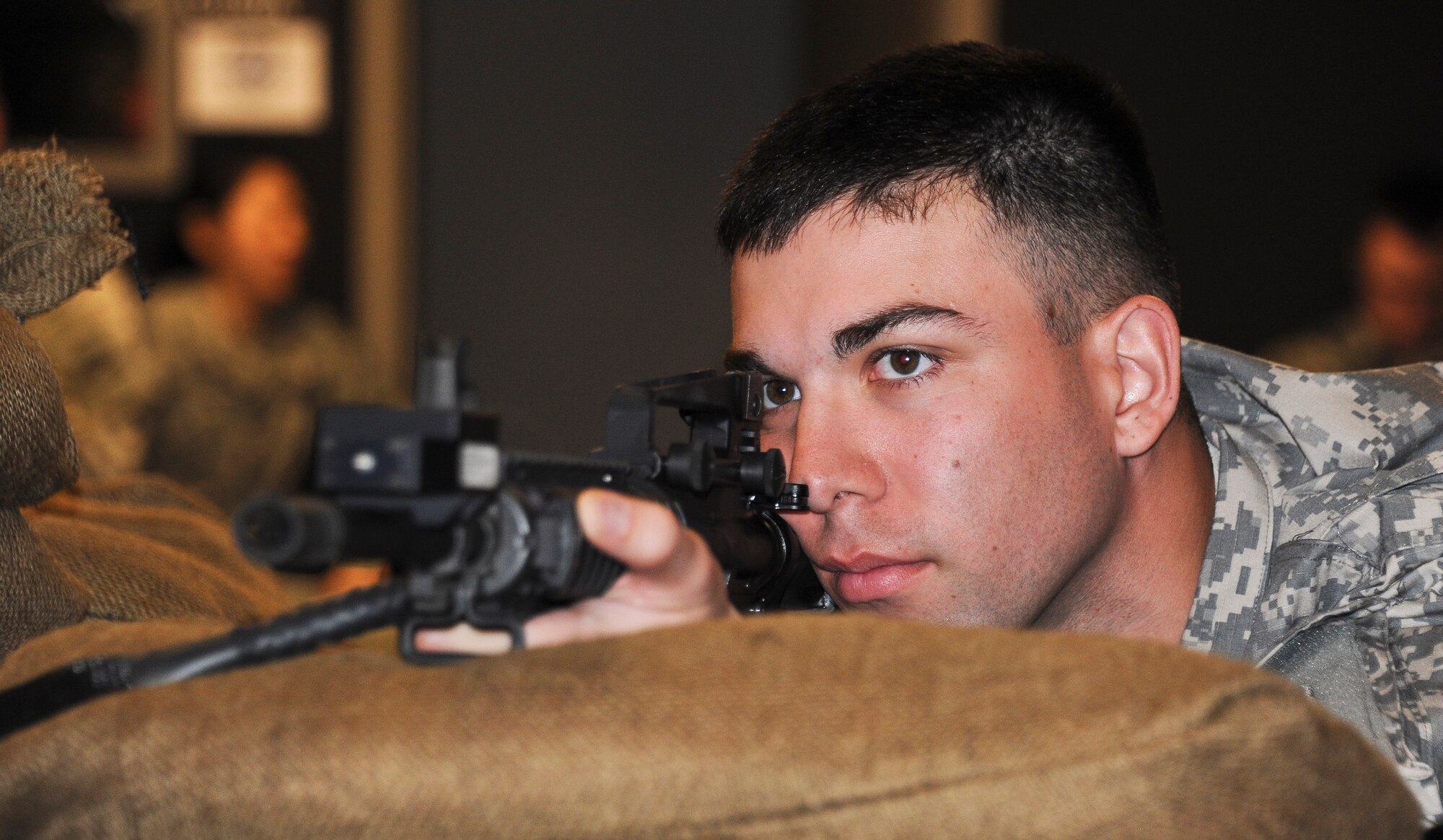 Sergeant 1st Class Jeffrey Rios, 78th Training Division Regional Training Center-East instructor from Yonkers, N.Y., targets simulated enemies while using the Engagement Skills Trainer 2000 program at the 99th Regional Support Center during 2012’s Best Warrior Competition March 5 here. The Best Warrior Competition is a test of the Soldiers' military knowledge, skills and physical fitness. (Photo by Airman 1st Class Ryan Throneberry)