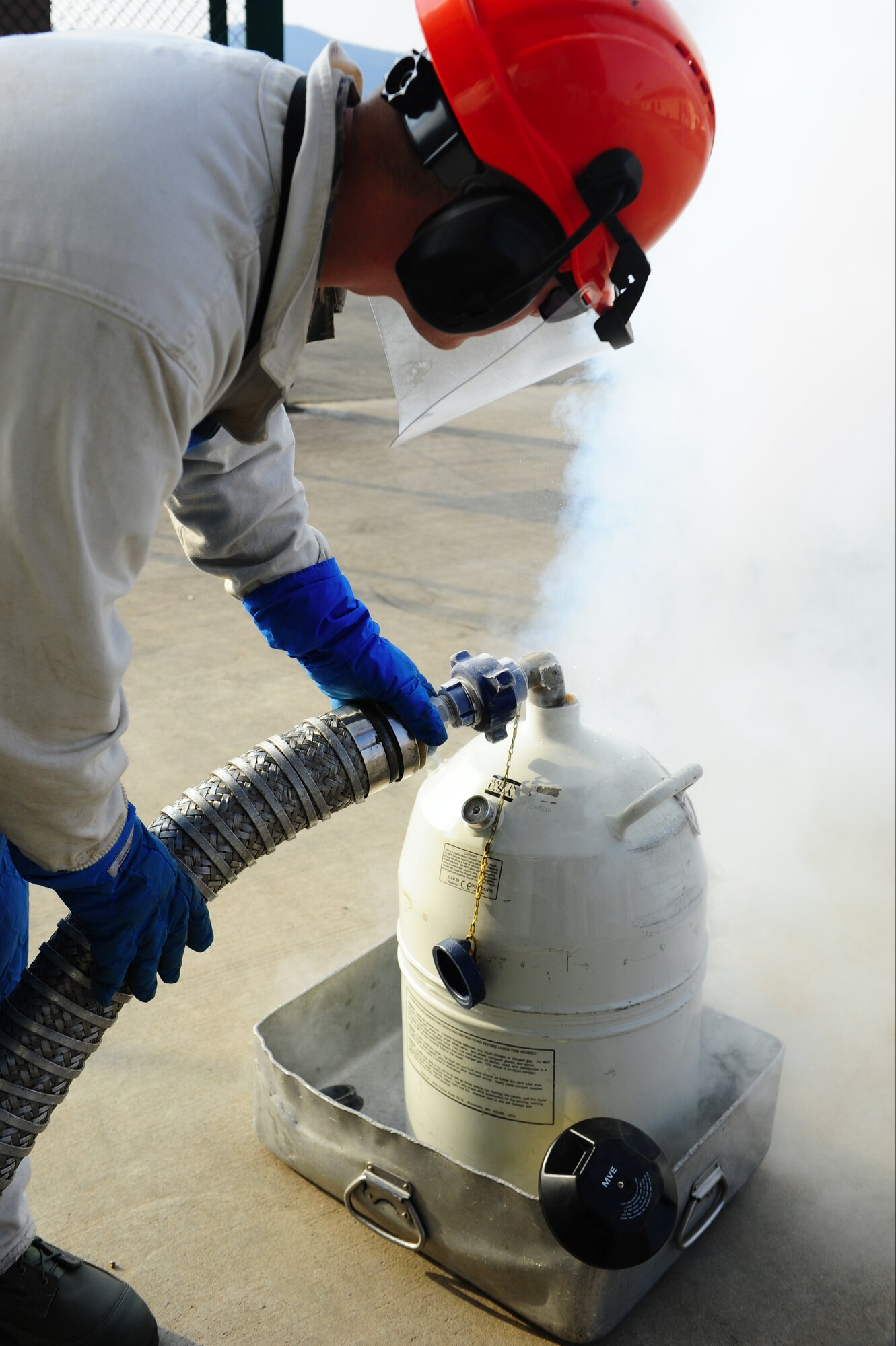 Air Force Staff Sgt. Robert Purnell, 86th Logistics Readiness Squadron
fuels cryogenics technician, fills a liquid nitrogen dewar, Ramstein Air
Base, Germany, March 6, 2012. LIN is used to support aircraft operations
and maintenance as well as lab environments. (U.S. Air Force photo/ Airman 
Brea Miller)