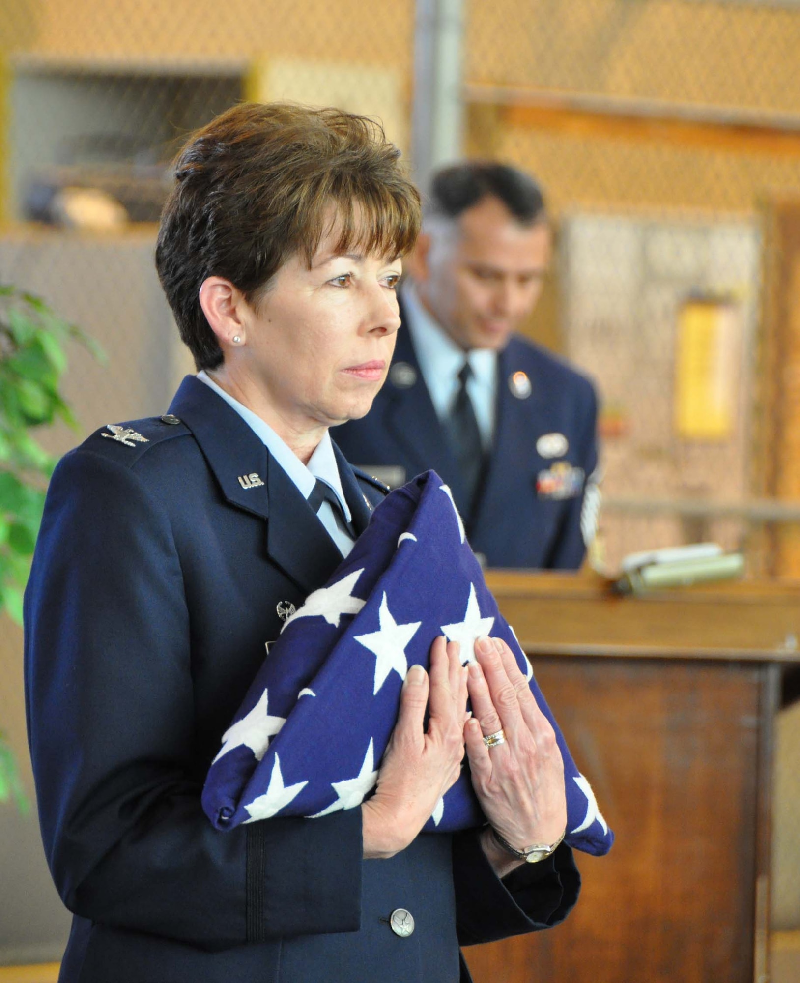 Colonel Pamela Scott embraces an American flag during her retirement ceremony held March 4, 2012 at the Kelly Annex. The flag was presented to her by the 433rd Airlift Wing Honor Guard in honor of her 30 years of service to both the Air Force active duty and Reserve components. After accepting the flag, Scott encouraged Airmen to consider changes and hardships as opportunities to move forward in both their military career and personal lives.  (U.S. Air Force photo/Senior Airman Viola Hernandez)    