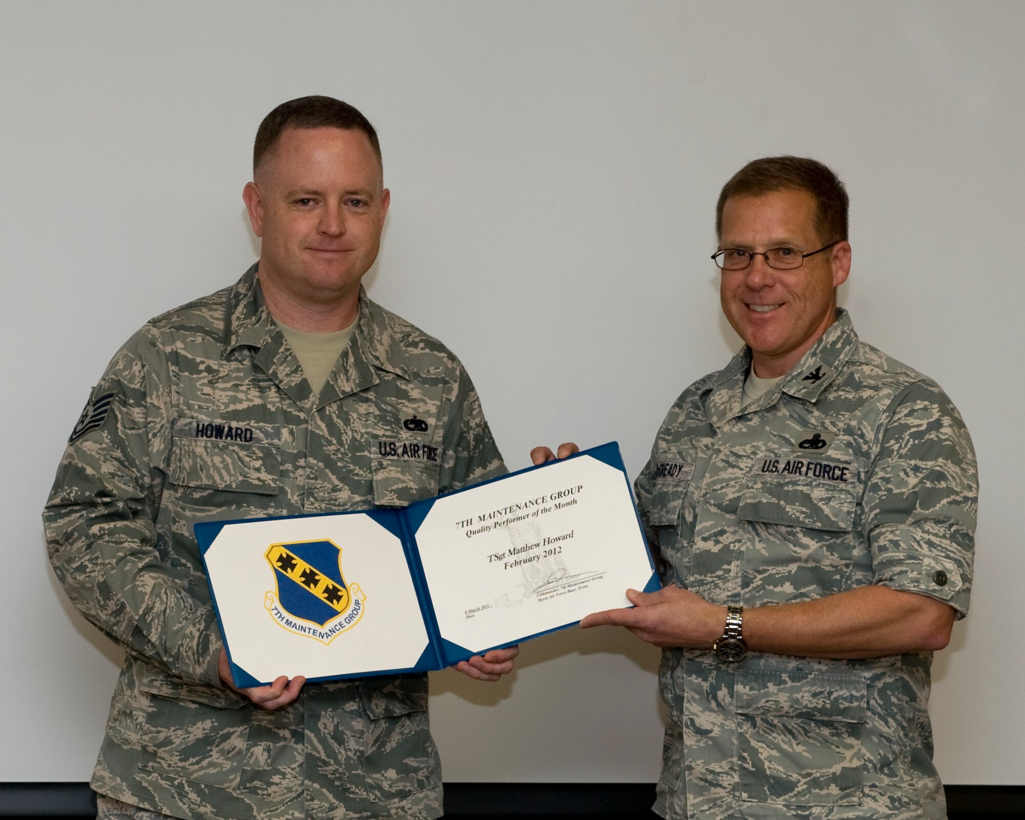 U.S. Air Force Col. Todd McCready, 7th Maintenance Group commander, presents Tech. Sgt. Matthew Howard, 7th MXG, with the February 7th MXG superior performer award, March 8, 2012, at Dyess Air Force Base, Texas. Every month each group selects a person or team who has shown superior performance to be recognized in front of wing leadership. (U.S. Air Force photo by Airman 1st Class Jonathan Stefanko/ Released)