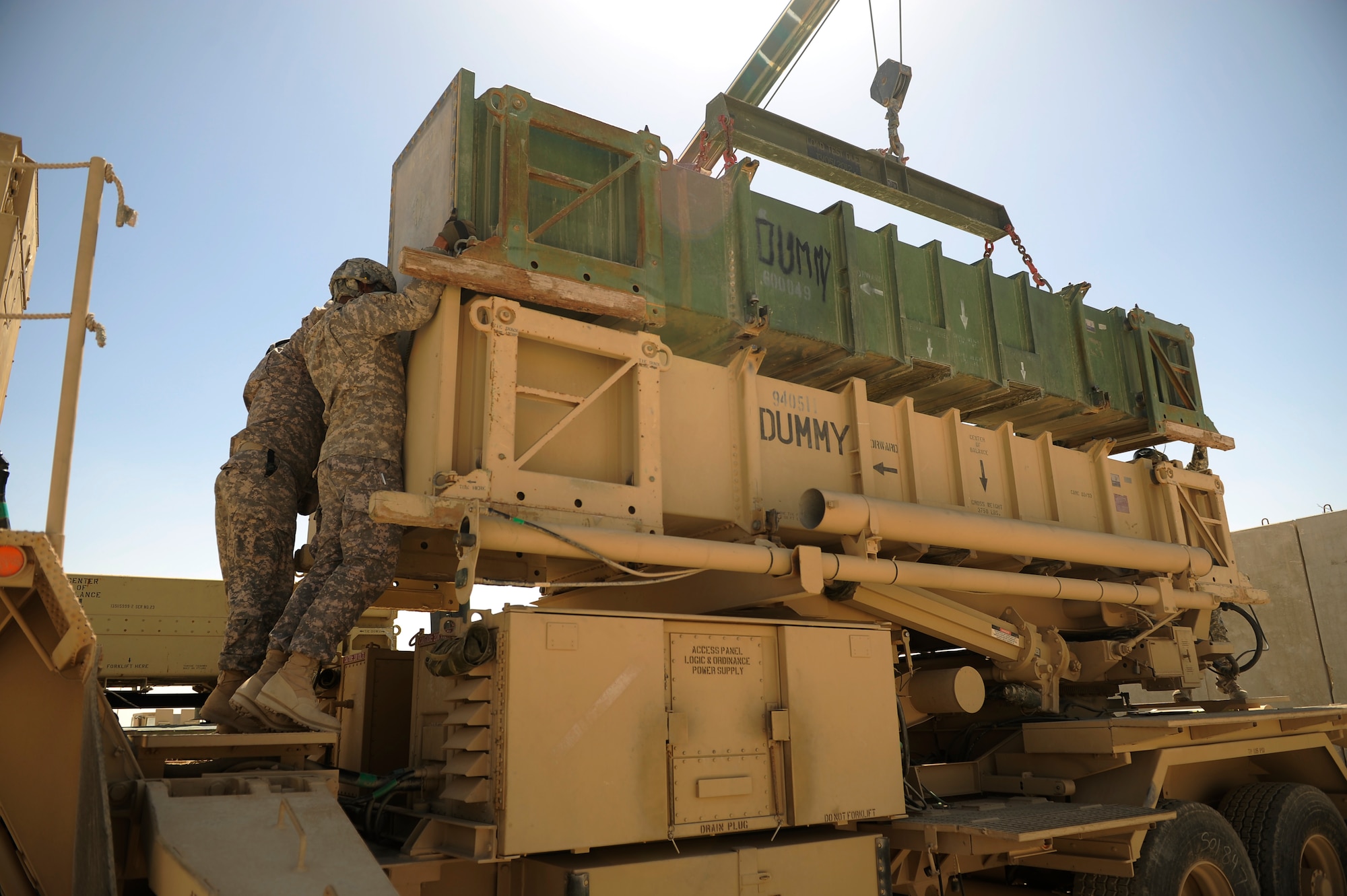 SOUTHWEST ASIA – U.S. Army Staff Sgt. Christopher Burnham and Spc. Mervin Moore, Bravo 5-52nd Air and Missile Defense Battery launcher station technicians, secure a launcher canister during a crew drill here March 6, 2012. The air defense artillery battery plays an important role in the region’s security and works daily to maintain their mission proficiency. (U.S. Air Force photo/Staff Sgt. Nathanael Callon)