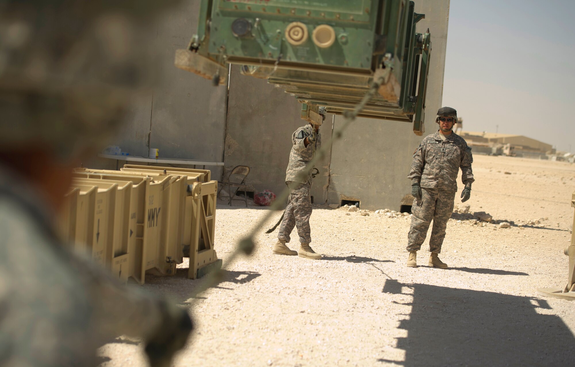 SOUTHWEST ASIA – U.S. Soldiers from the Bravo 5-52nd Air and Missile Defense Battery lower a launcher canister during a crew drill here March 6, 2012. Each member plays a vital role in accomplishing the mission, and no one Soldier is more important than the other. (U.S. Air Force photo/Staff Sgt. Nathanael Callon)