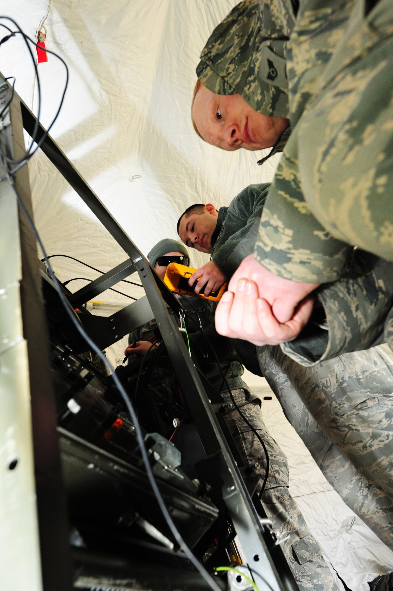 Staff Sgt. James Welker, 1st Combat Communication Squadron airfield system technician, works on on power supply for the tactical air navigation system panel during a Quick Reflex Exercise, Ramstein Air Base Germany, March 9, 2012. The QRE is to test new unit type code and to familiarize Airman apart of the 1st CCBS with what is expected from them when they are deployed. (U.S. Air Force photo/Senior Airman Aaron-Forrest Wainwright)