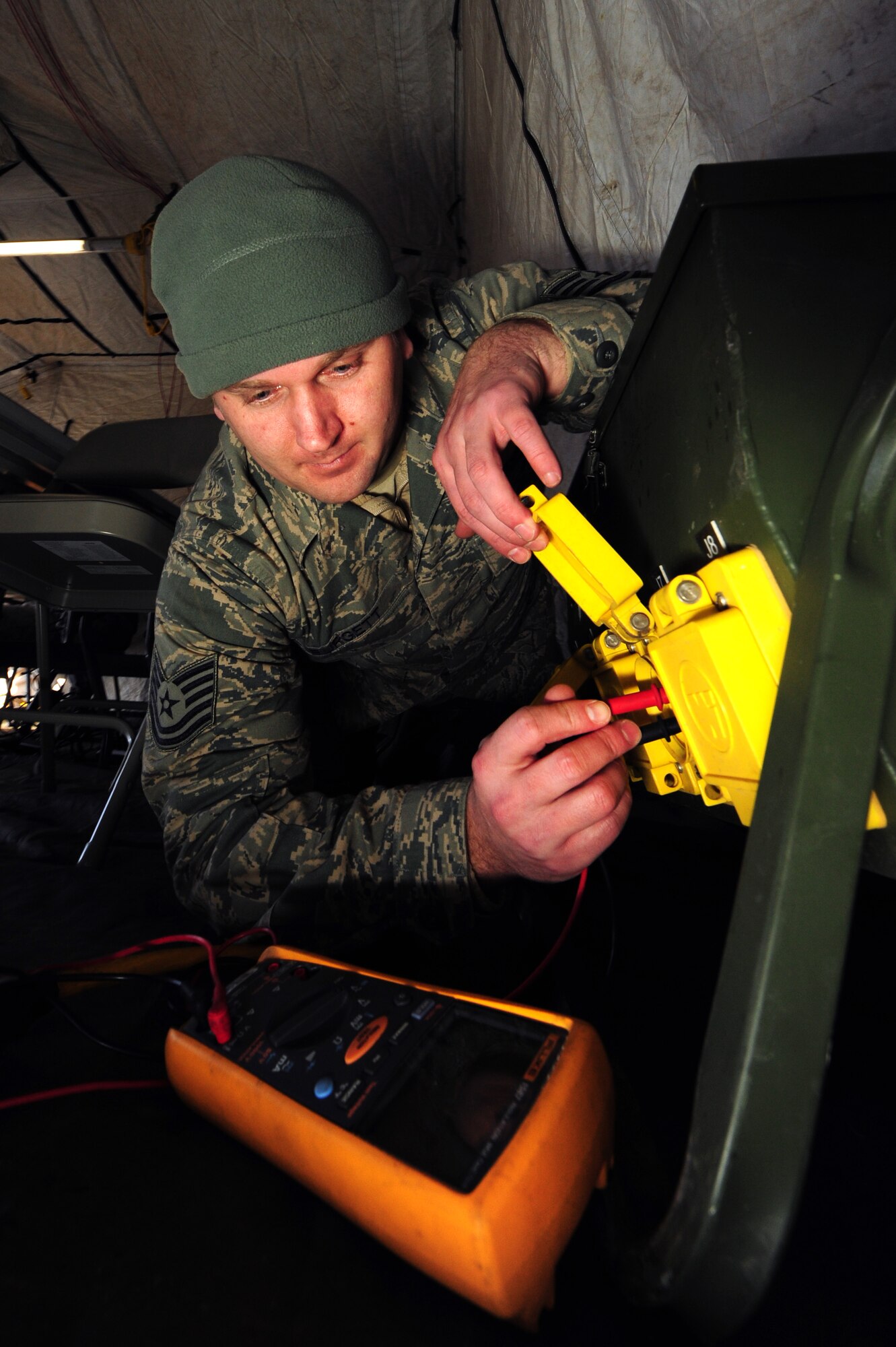 Tech. Sgt. Shawn Burgett, 1st Combat Communication Squadron power production technician, checks the voltage on the power distribution panel during a Quick Reflex Exercise, Ramstein Air Base Germany, March 09, 2012. The QRE is to test new unit type code and familiarize Airmen of the 1st Combat Communication Squadron with what is expected from them when they are deployed. (U.S. Air Force photo/Senior Airman Aaron-Forrest Wainwright)