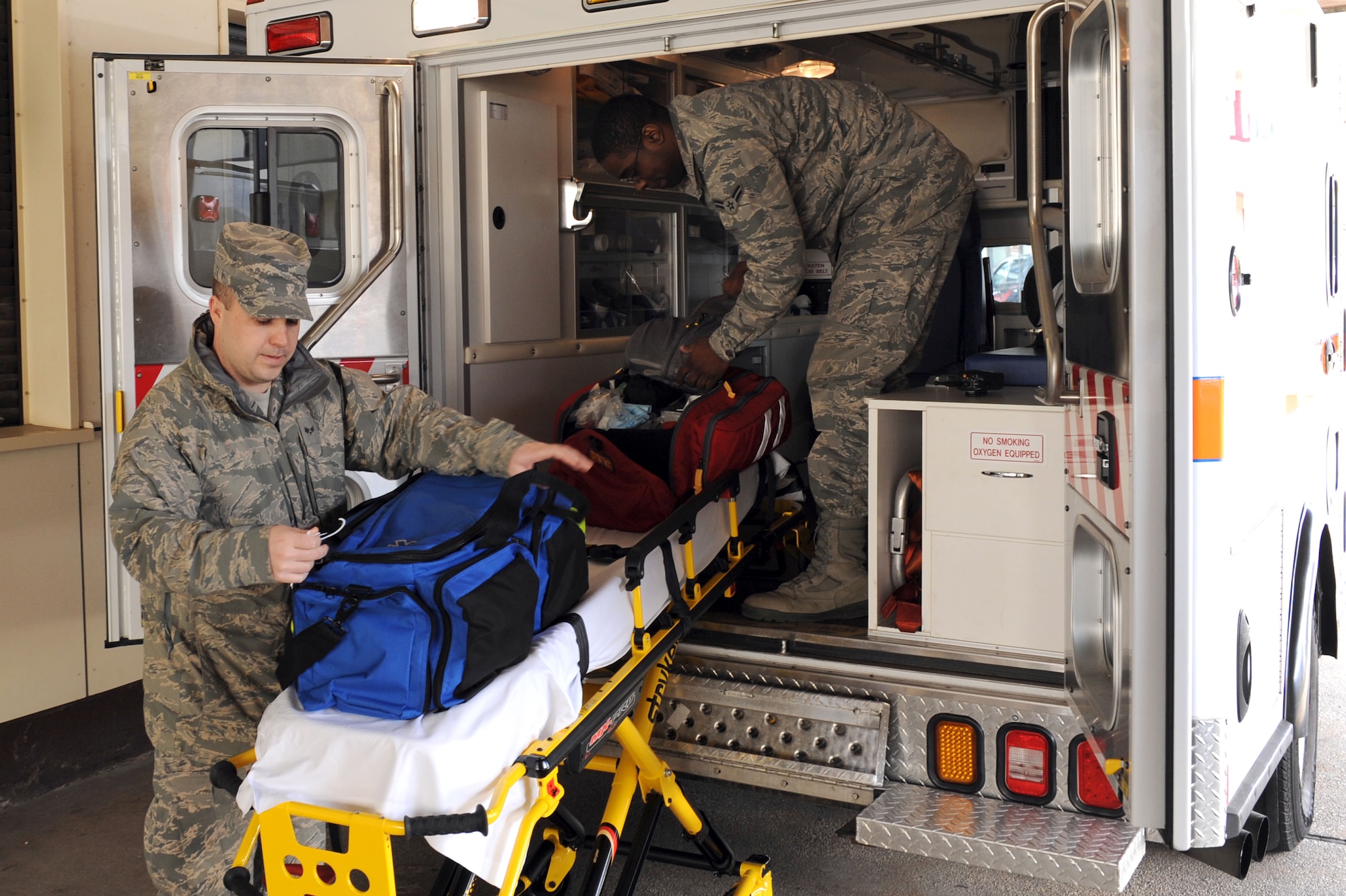 SPANGDAHLEM AIR BASE, Germany – Senior Airman Oliver Martin and Airman 1st Class Derrick Hogans, 52nd Medical Operations Squadron ambulance service technicians, function check equipment prior to working their shift at Bldg. 137 here March 8. Function checks of all emergency equipment are conducted by technicians at the beginning of every shift. Ambulance techs provide initial medical response on Spangdahlem AB to support base response to in-flight and other mission related emergencies, as well as any other on-base incidents. The ambulance service provides emergency care for more than 8,400 Airmen, department of defense civilians, and their families. (U.S. Air Force photo by Senior Airman Christopher Toon/Released)