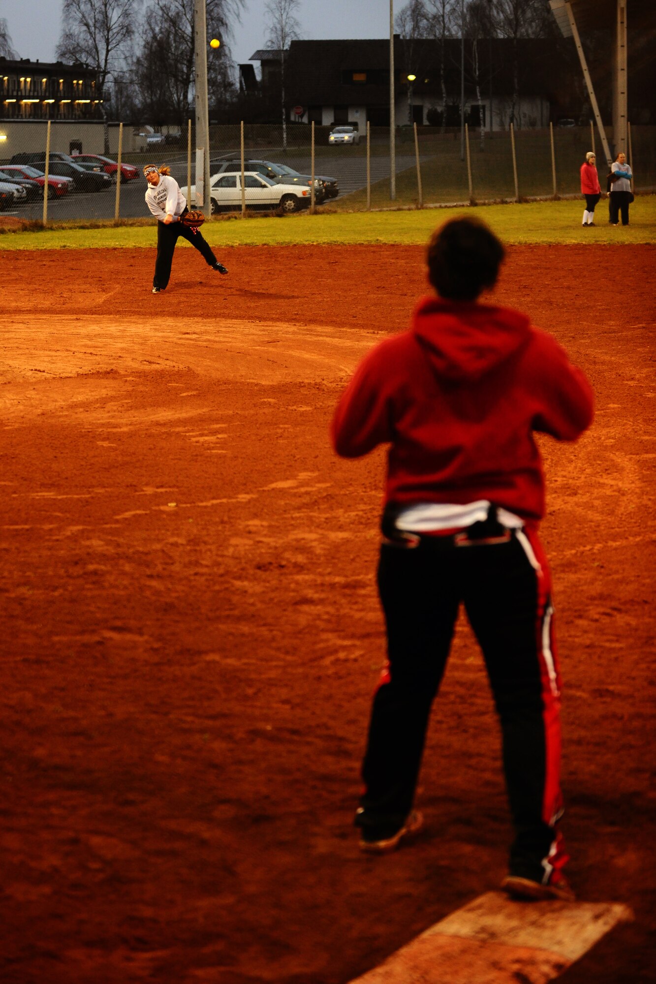 SPANGDAHLEM AIR BASE, Germany – Lindsey Gruber, 52nd Security Forces Squadron, throws a softball to Lynsey Bruzzi, SFS, during Spangdahlem Lady Sabers varsity softball team tryouts at varsity field 1 here March 7. The softball team held tryouts until March 9. The varsity softball team competes in tournaments throughout Europe playing against other Air Force, Army and Navy teams. (U.S. Air Force photo by Airman 1st Class Matthew B. Fredericks/Released)