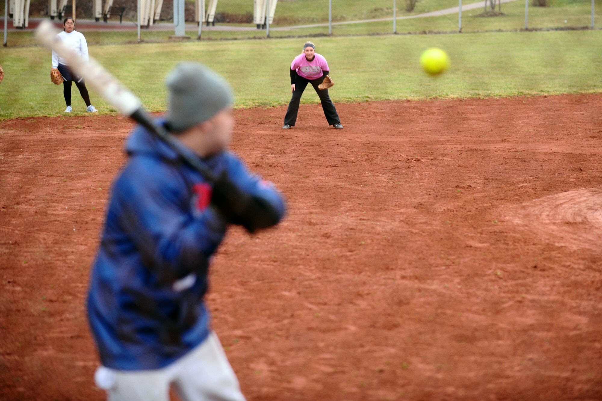 SPANGDAHLEM AIR BASE, Germany – Kristen Gieras prepares to field a ball hit by Spangdahlem Sabers varsity softball team member Jason De La Vega, 52nd Component Maintenance Squadron, during Spangdahlem Lady Sabers varsity softball team tryouts at varsity field 1 here March 7. The softball team held tryouts until March 9. The varsity softball team competes in tournaments throughout Europe playing against other Air Force, Army and Navy teams. (U.S. Air Force photo by Airman 1st Class Matthew B. Fredericks/Released)
