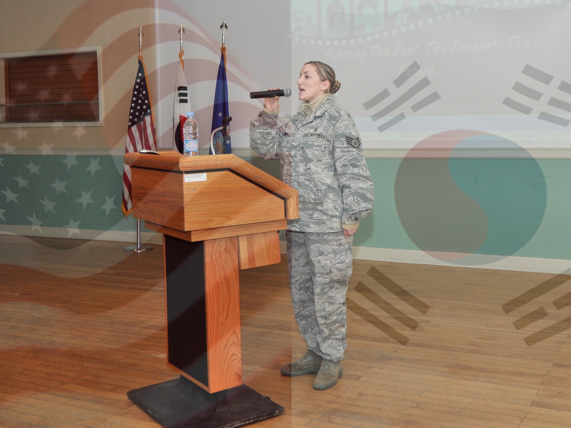 Then-Staff Sgt. Amanda “Mae” O’Brien, 8th Medical Group unit deployment manager, performs “The Star-Spangled Banner” at an event Feb. 17, 2012. O’Brien is known for being able to sing both the American national anthem and the South Korean “Aegukga.” (U.S. Air Force photo by Senior Airman Brittany Y. Auld, illustration by Senior Airman Brigitte N. Brantley/Released)