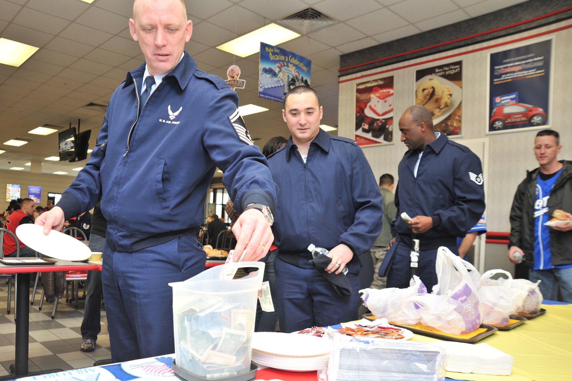 Senior Master Sgt. Shawen Stolz, 8th Security Forces Squadron, donates money to the Air Force Assistance Fund during the AFAF kickoff at Kunsan Air Base, Republic of Korea, Mar. 5, 2012. Kunsan’s goal for this year’s AFAF campaign is $43,000 and this year’s theme is commitment to caring. (U.S. Air Force photo by Senior Airman Brittany Y. Auld/Released)
