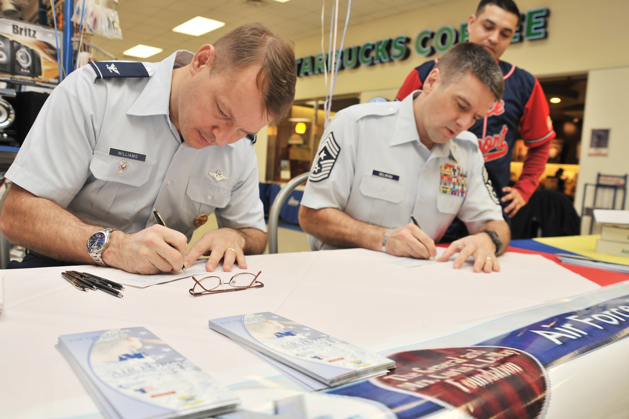 Col. Stephen Williams, 8th Fighter Wing vice commander, and Chief Master Sgt. Scott Delveau, 8th FW command chief, fill out an Air Force Assistance Fund form during the kickoff event at Kunsan Air Base, Republic of Korea,  Mar. 5, 2012. Kunsan’s goal for this year’s AFAF campaign is $43,000 and this year’s theme is “Commitment to Caring.”  (U.S. Air Force photo by Senior Airman Brittany Y. Auld/Released)