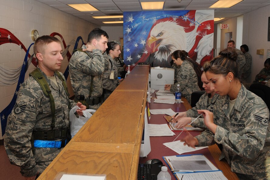 Airmen process through a simulated personnel deployment function line in the Personnel Deployment Facility at Seymour Johnson Air Force Base, N.C., Mar. 5, 2012. The line is the last quality assurance check Airmen receive before deploying. (U.S. Air Force photo/Airman 1st Class John Nieves Camacho/Released)