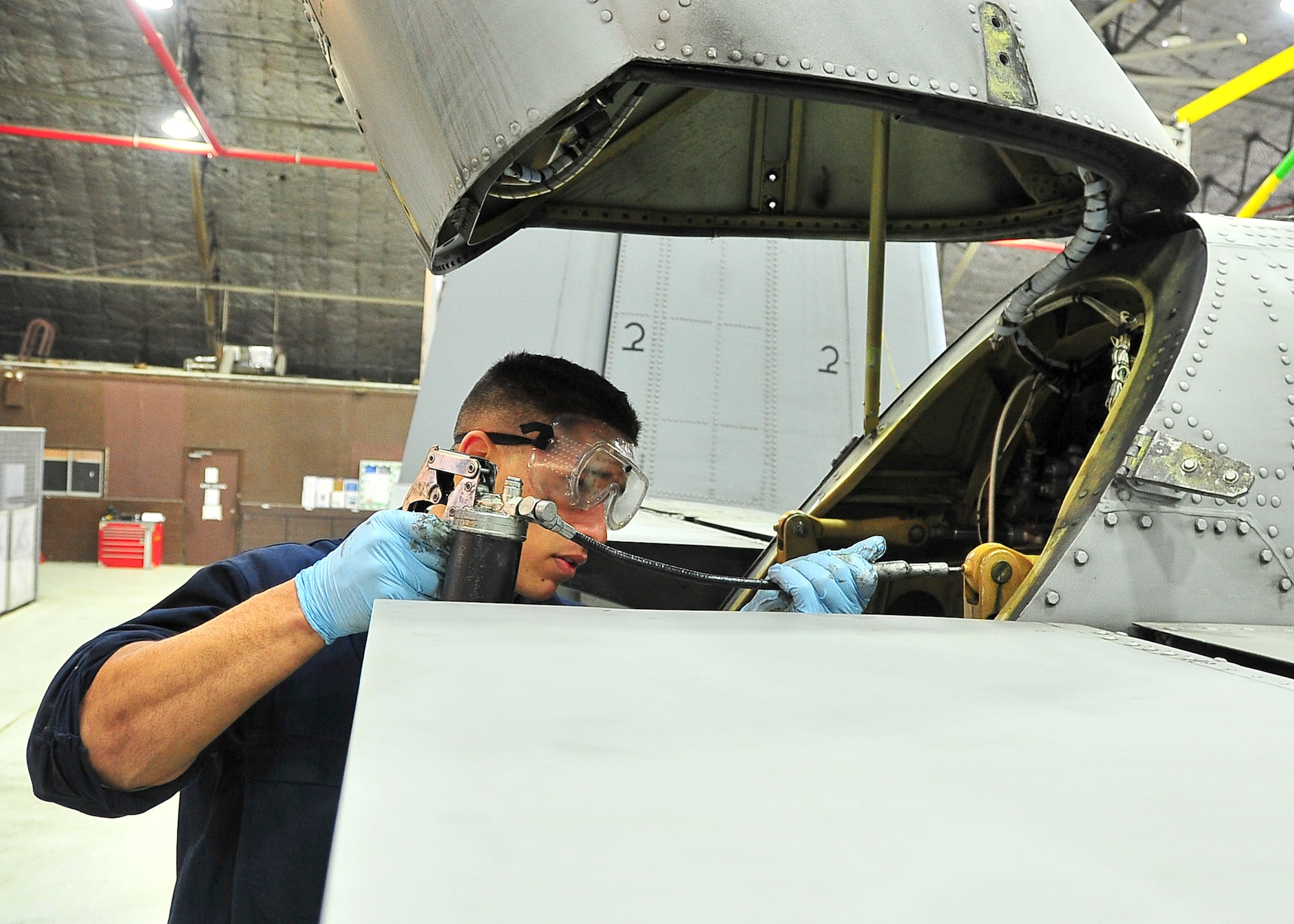 Senior Airman Christopher Blackstone, 51st Maintenance Squadron phase crew chief, applies lubrication to different parts of an A-10 here, March 7, 2012. The lubrication placed on the different parts of the aircraft ensures the aircraft maneuvers properly. (U.S. Air Force Photo/ Senior Airman Adam Grant)

