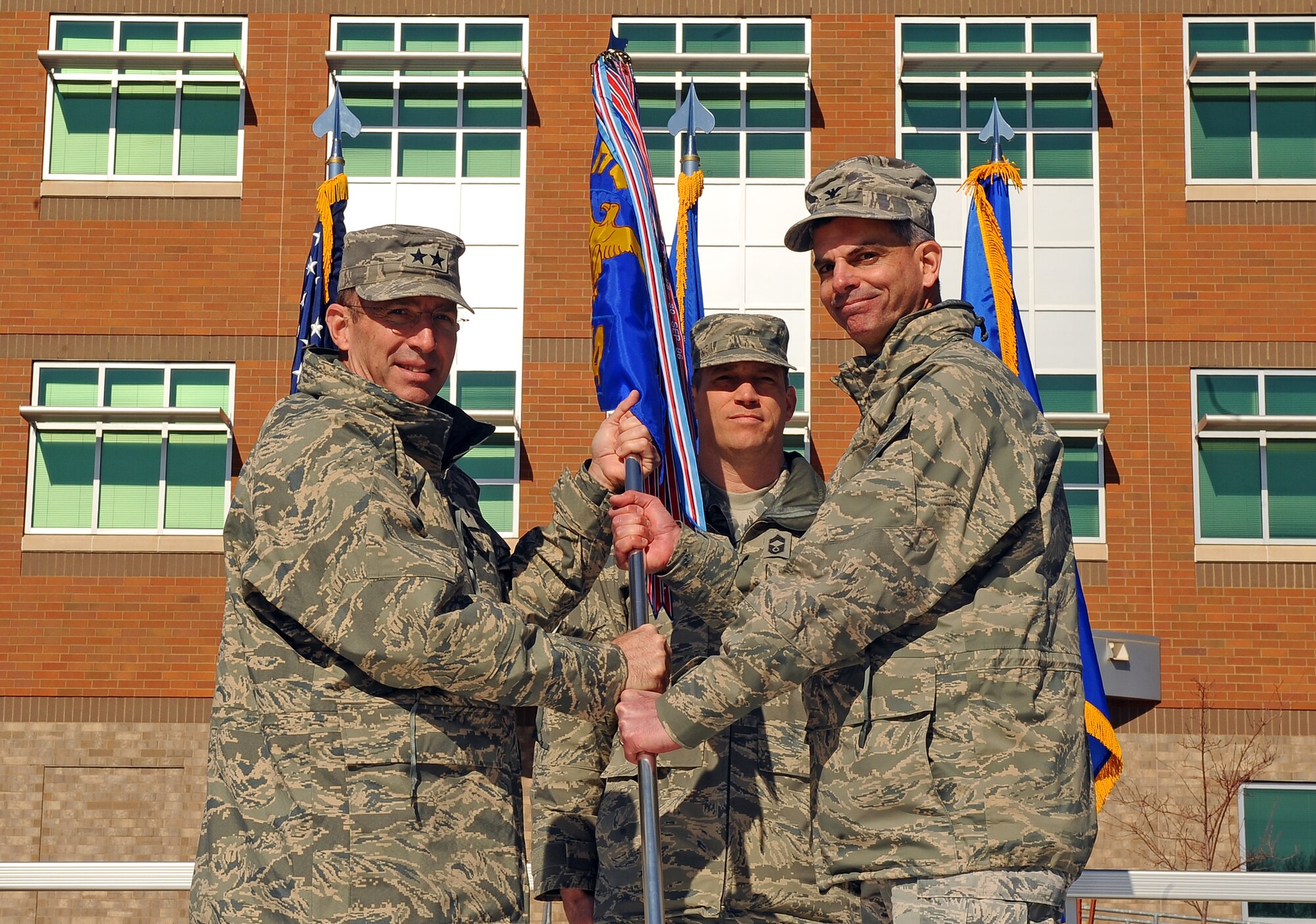 OFFUTT AIR FORCE BASE, Neb. -- Maj. Gen. Brett T. Williams, the Air Force's director of operations and deputy chief of staff for operations, plans and requirements, hands the guidon to Col. Louis Zuccarello, designating him as the new Air Force Weather Agency commander, during a change of command ceremony here March 9. Zuccarello takes over after serving as vice commander since February 2011.