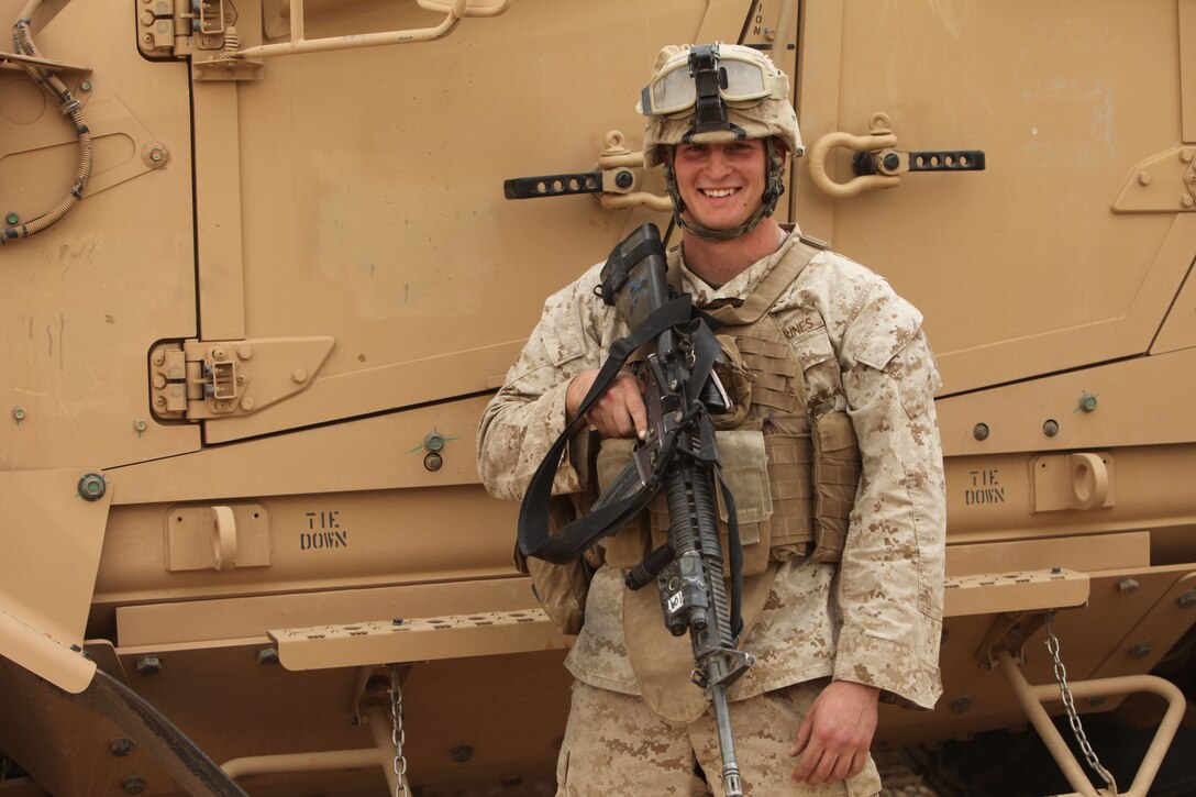 Marine Corps Cpl. Matthew Kirby stands in front of his vehicle at Camp Dwyer, Afghanistan. U.S. Marine Corps photo by Cpl. Michele Watson