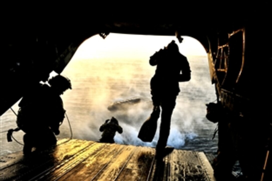 Members of Air Force Special Operations weather teams participate in a training scenario on a CH-47 Chinook during Emerald Warrior at Hurlburt Field, Fla., March 7, 2012. The primary purpose of Emerald Warrior is to exercise special operations components in urban and irregular warfare settings to support combatant commanders in theater campaigns.