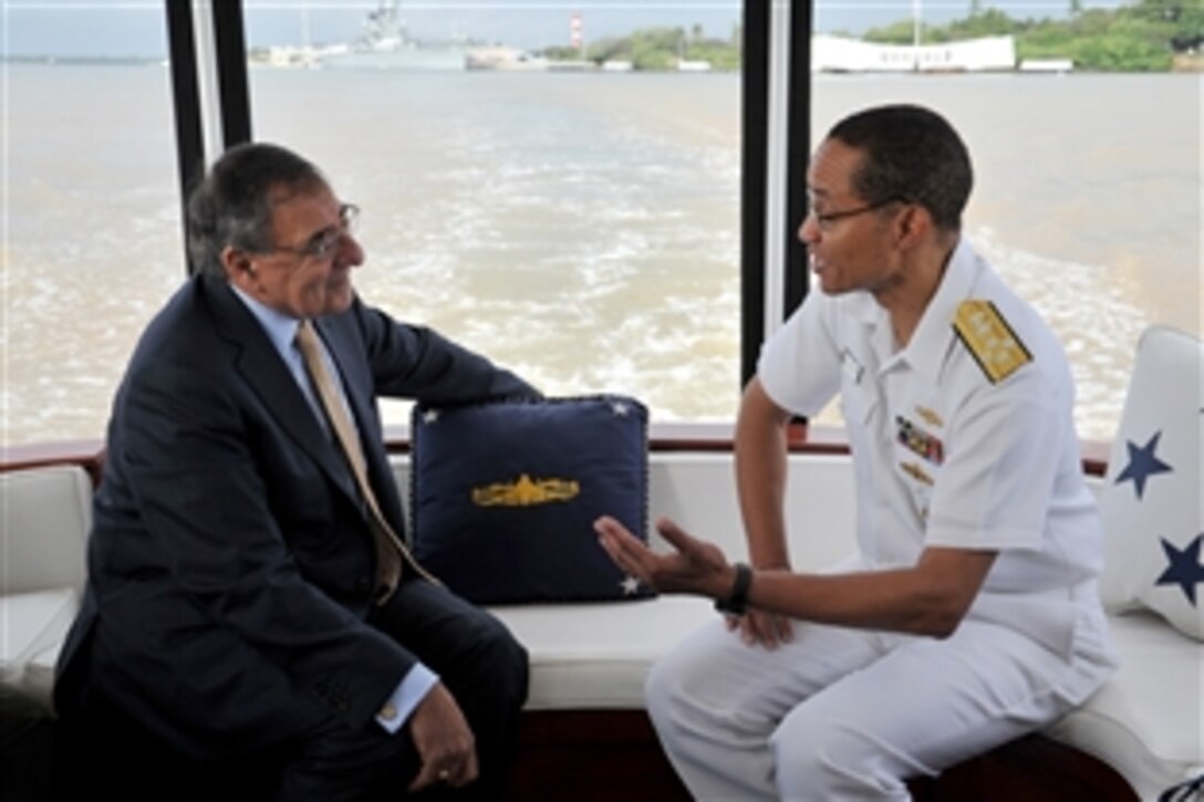 Defense Secretary Leon E. Panetta, left, and Navy Adm. Cecil D. Haney, commander of U.S. Pacific Fleet, discuss the Japanese attack on Pearl Harbor after a wreath-laying ceremony at the USS Arizona in Pearl Harbor, Hawaii, March 9, 2012. Panetta was in Hawaii to participate in U.S. Pacific Command's change-of-command ceremony. 