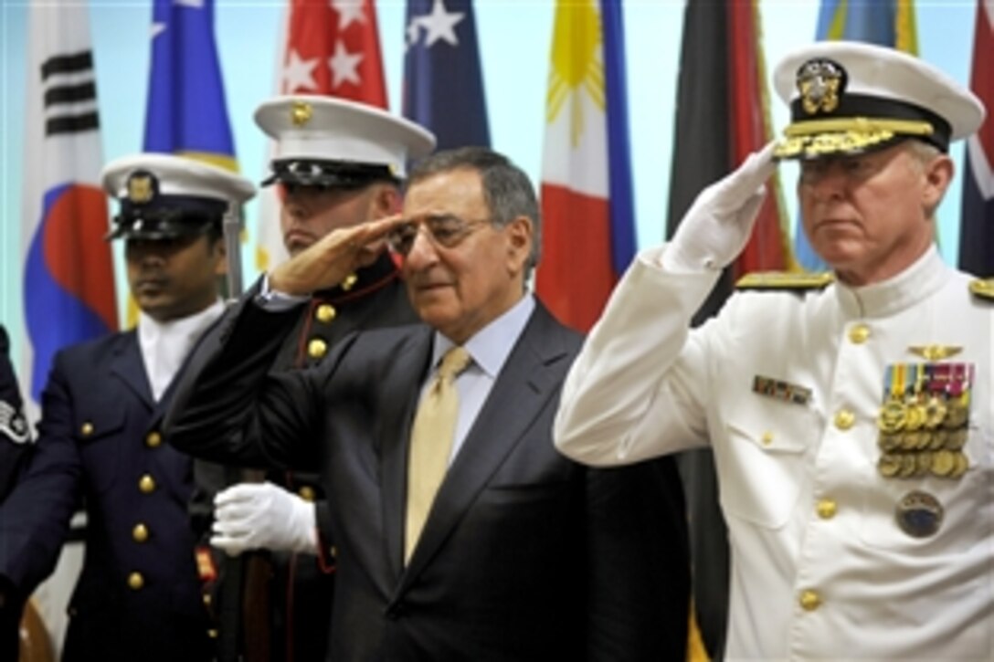 Defense Secretary Leon E. Panetta, center, salutes during the U.S. Pacific Command change-of-command ceremony on Camp H.M. Smith, Hawaii, March 9, 2012. Navy Adm. Robert F. Willard, right, relinquished command to Navy Adm. Samuel J. Locklear III and retired after nearly 39 years of Navy service.