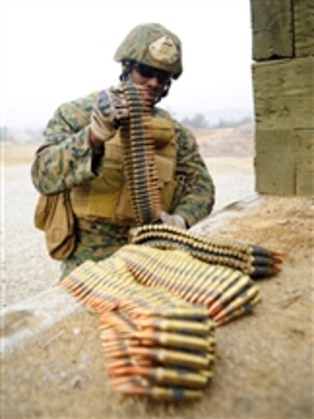 U.S. Marine Corps Sgt. Wendall Claxton, assigned to Fleet Antiterrorism Security Team Company Pacific, 2nd Platoon, prepares M240 machine gun ammunition before conducting a live-fire exercise at Camp Rodriguez, South Korea, on March 8, 2012.  