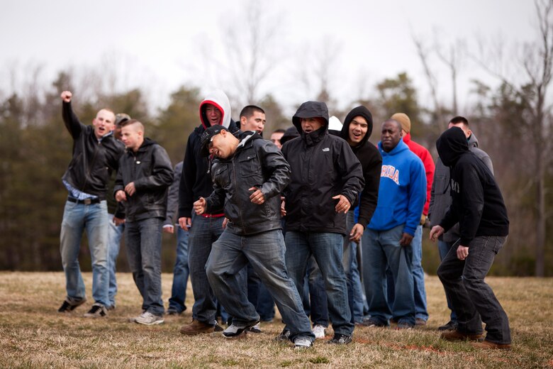 Field radio operator, Sgt. Frank Torres, and his group of riff-raffs retreat after being hit by a wave of hot air from the Active Denial System during a demonstration at Marine Corps Base Quantico, Va., March 9. The ADS is a non-lethal weapon that projects a long range, man-sized beam of millimeter waves that produce a reversible heating sensation to the skin, much like opening a hot oven. It is one of many non-lethal weapons the Marine Corps is looking to deploy into combat zones to minimize casualties and collateral damage. It can be used for perimeter defense, crowd control and area denial against any human threat. Torres and the other Marines simulated scenarios where the ADS could be used.