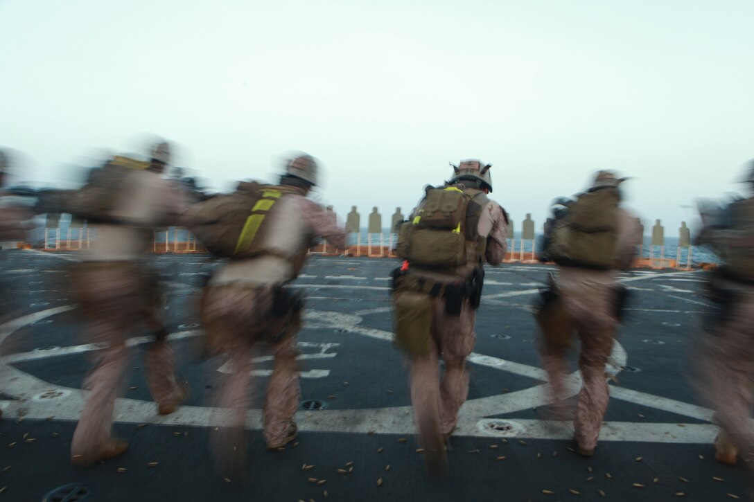 Marines with the 11th Marine Expeditionary Unit's maritime raid force walk toward targets before firing aboard USS New Orleans here March 9. The unit is deployed as part of the Makin Island Amphibious Ready Group, a U.S. Central Command theater reserve force. The group is providing support for maritime security operations and theater security cooperation efforts in the U.S. Navy's 5th Fleet area of responsibility.