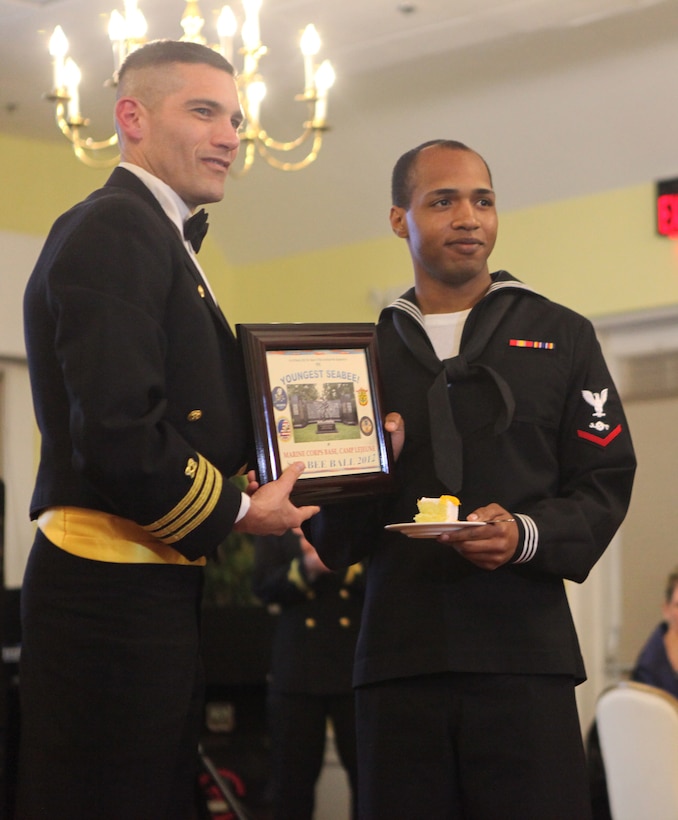 Traditionally, the Seabee ball recognizes the youngest and eldest Seabees in attendance with a cake cutting ceremony, drawing the past and present together. Navy Cmdr. Marc R. Delao, commanding officer, Officer in Charge of Construction, Marine Corps Instillation East, presented the youngest and eldest Seabees with a plaque to commemorate the event and to recognize them for their role in the evening’s ceremony.