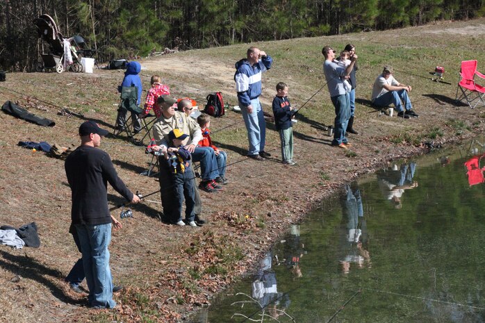 Zelan Garcia, a Cub Scout master, teaches his son how to cast during the Family Fun Fishing event, hosted by the Outdoor Adventures branch of Marine Corps Community Services at Orde Pond aboard Marine Corps Base Camp Lejeune, March 10. More than 200 patrons registered for the event.