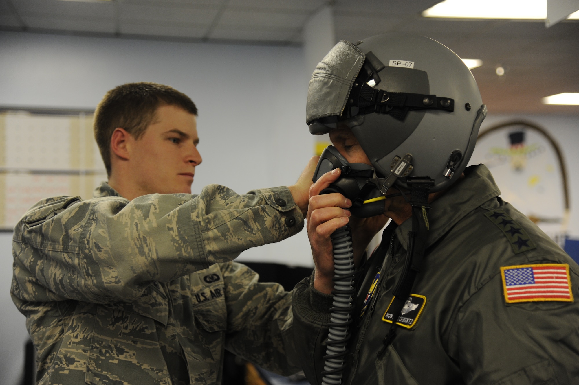 LAUGHLIN AIR FORCE BASE, Texas—Airman Jacob Pearce, 47th Operations Support Squadron, conducts a helmet fitting on Air Force Chief of Staff Gen. Norton Schwartz in preparation for a T-6 Texan II sortie here March 9. Schwartz was a keynote speaker at the graduation of Specialized Undergraduate Pilot Training Class 12-06, where 23 new pilots were awarded silver wings. (U.S. Air Force photo/Airman 1st Class Nathan L. Maysonet) 