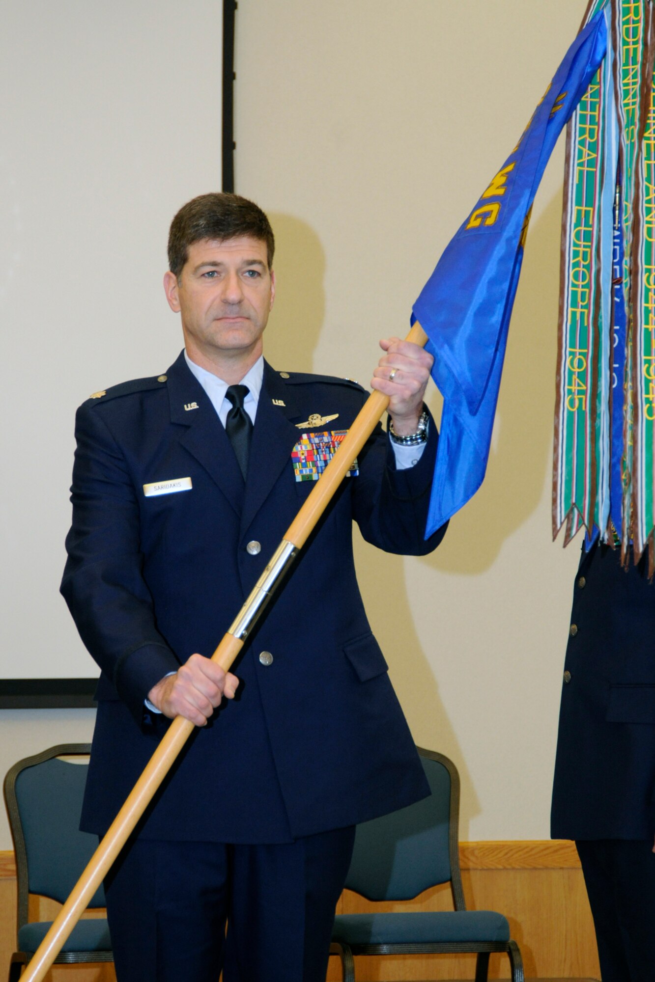 Lt. Col. Emmanuel Saridakis holds the 107th Fighter Squadron guidon after assuming command of the squadron during a March 10, 2012, ceremony at Selfridge Air National Guard Base, Mich. Saridakis, an A-10 Thunderbolt pilot, relieved Lt. Col. Douglas Champagne, who took command of the 127th Operations Group. The banners on the guidon reflect the almost 100-year history of the 107th FS. (U.S. Air Force photo by TSgt. David Kujawa)