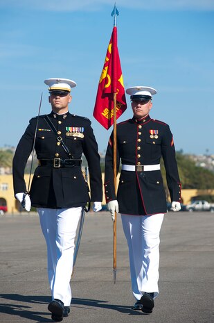 Capt. Edward Hubbard, left, the ceremony commander, and Pfc. Clayton Caley, a ceremonial guidon bearer, both with the Battle Color Detachment, march into their positions during an afternoon ceremony at Marine Corps Recruit Depot, San Diego, Calif., March 10, 2012.