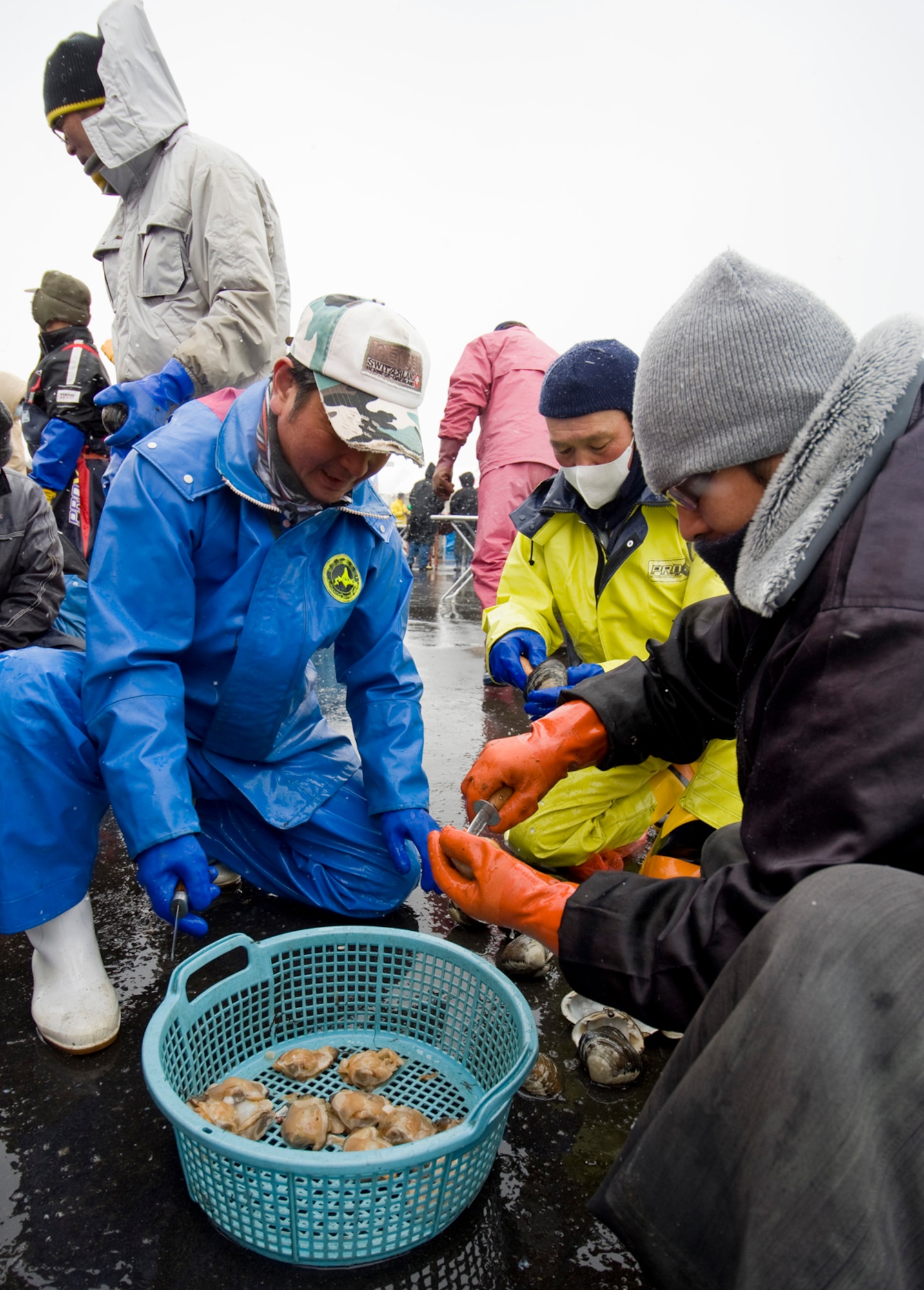 Japanese fishermen and volunteers shell clams to make stew during an earthquake/tsunami remembrance ceremony at the Momoishi Port, Oirase Town, Japan, March 11, 2012. Surrounding community members and Misawa Air Base, Japan community members attended the ceremony to remember the tragedy one year after a 9.0 earthquake-induced tsunami battered Japan?s northeast coast on March 11, 2011. The fishermen and farmers offered the stew to those who helped with the recovery efforts, including many from Misawa Air Base. (U.S. Air Force photo by Senior Airman Jess Lockoski/Released)