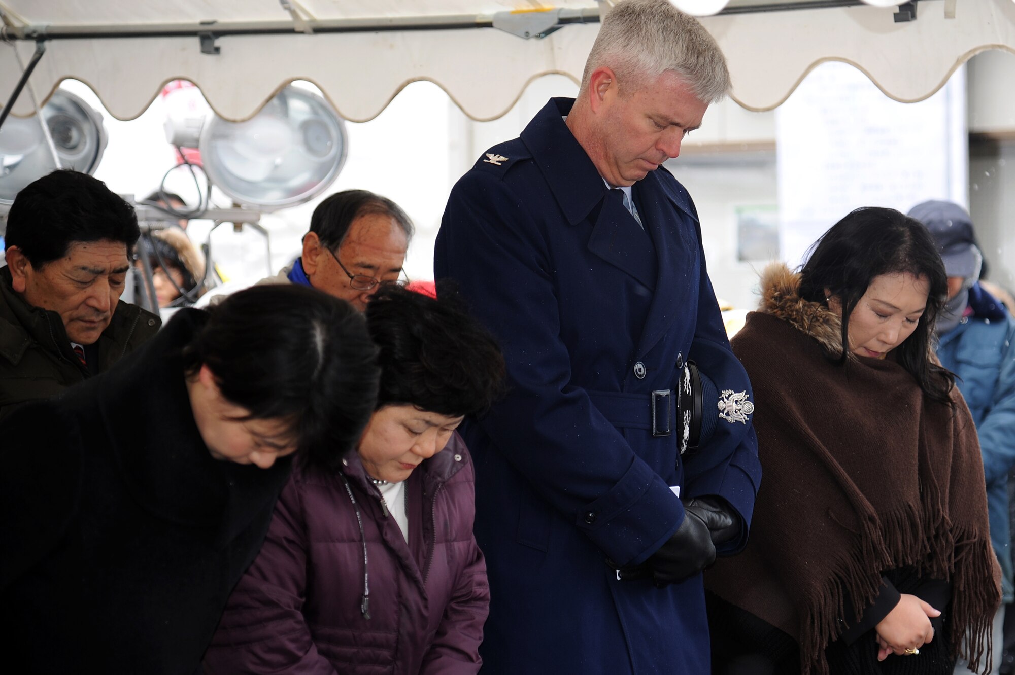 U.S. Air Force Col. Al Wimmer, 35th Fighter Wing vice commander, stands with members of the local Japanese community to observe a moment of silence to remember the victims of the March 11, 2011 earthquake and subsequent tsunami during a ceremony in Oirase Town, Japan, March 11, 2012. The 9.0 magnitude earthquake and tsunami took the lives of more than 16,000 people. (U.S. Air Force photo by Tech. Sgt. Marie Brown/Released)

