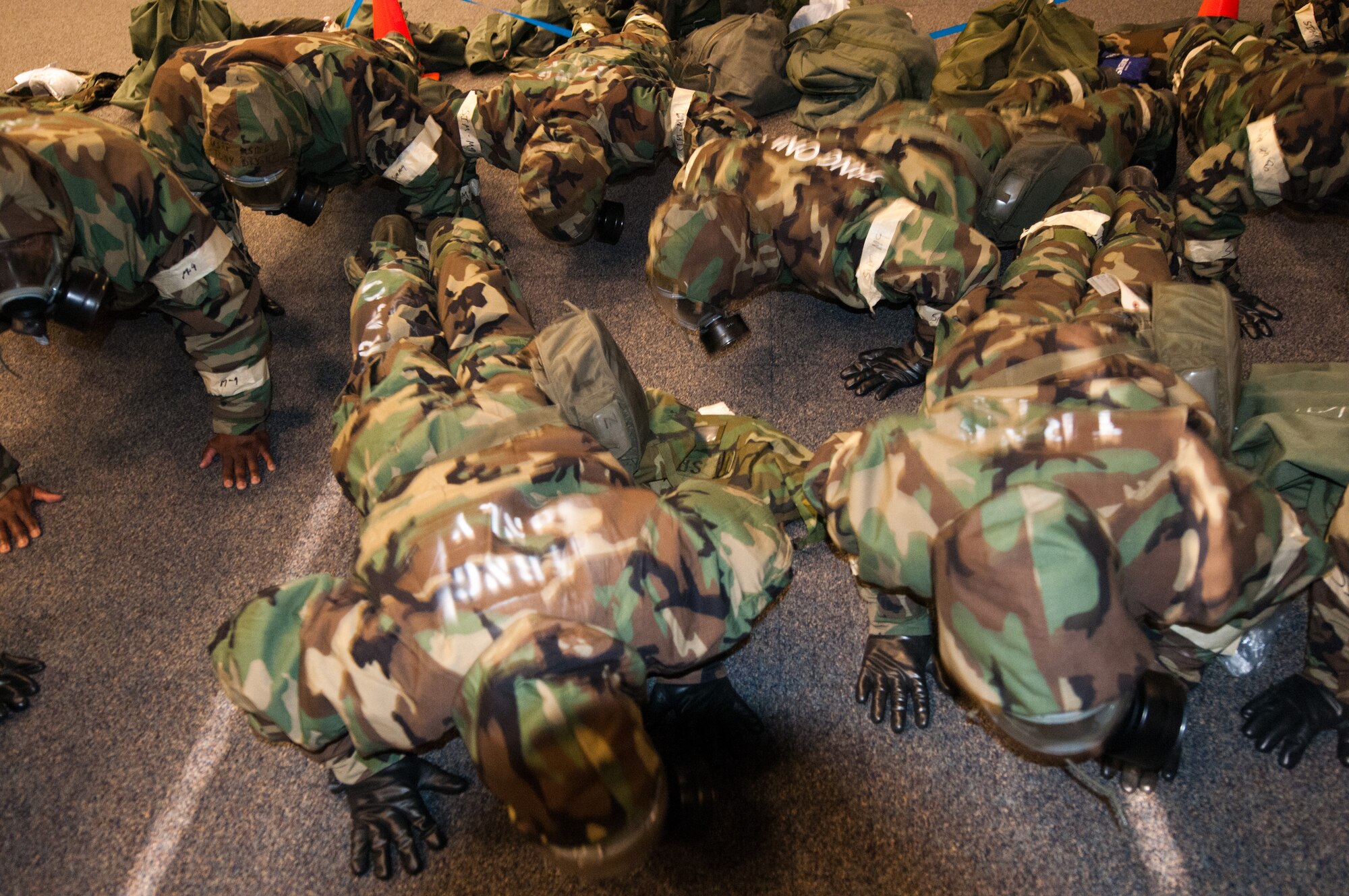 JOINT BASE ANDREWS, Md. – Members of the 459th Air Refueling Wing drop and give Staff Sgt. Francis, MOPP four drills instructor 10 pushups, Feb. 12. Approximately three hundred 459ARW members participated in Mission Oriented Protective Posture 4 drills, one of six training session to prepare for the Operational Readiness Exercise in March and Operational Readiness Inspection in May. (U.S. Air Force photo by Sophia Piellusch)