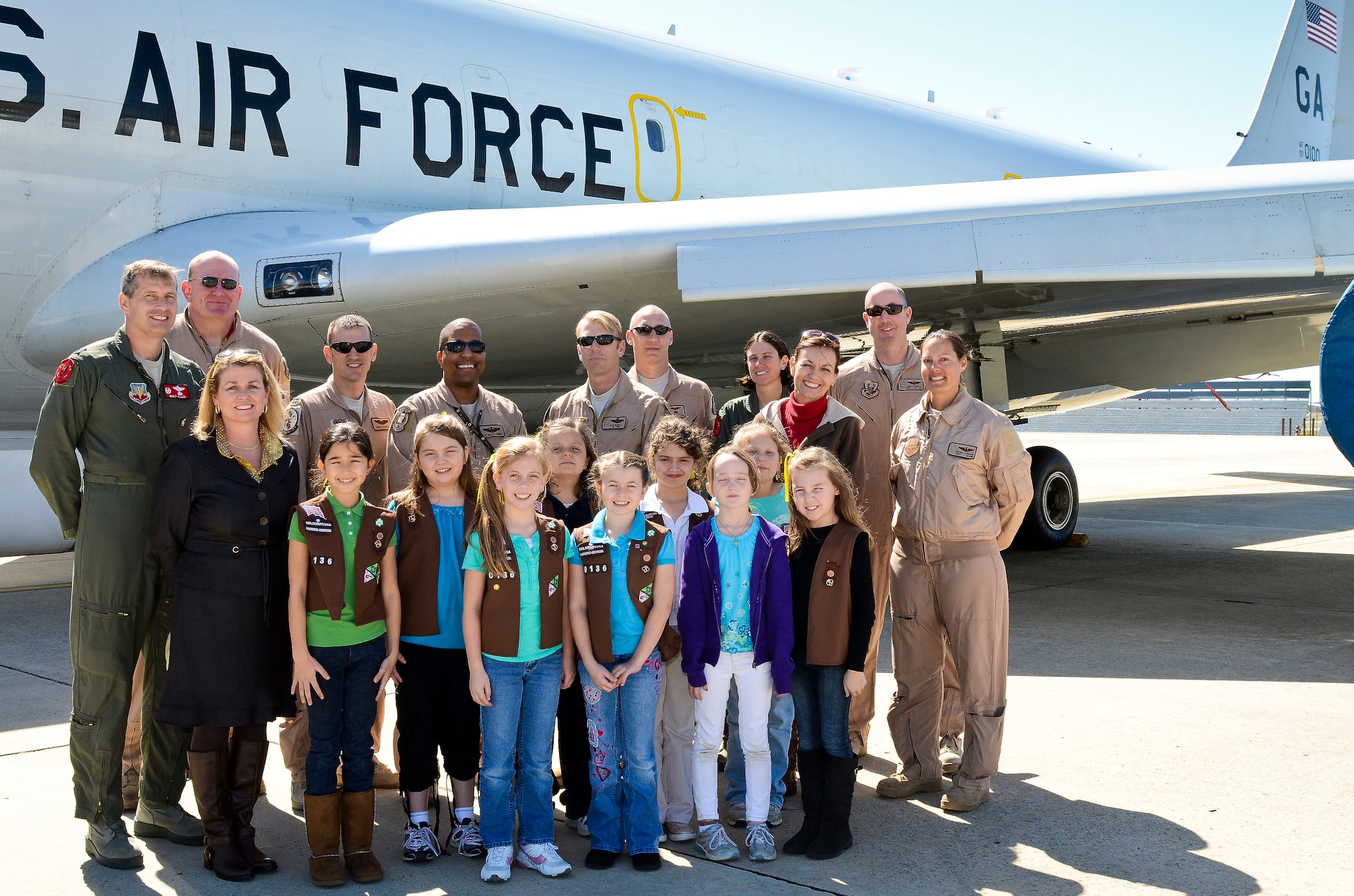 A group of Brownies and their leaders from Troop 60136, Warner Robins, Ga., pose with E-8 Joint STARS flight crew members during a tour at Robins Air Force Base, Ga., March 6, 2012.  The Brownie Troop toured the jet during a visit where they donated 129 boxes of the cookies to be delivered to deployed JSTARS members.  (National Guard photo by Master Sgt. Roger Parsons/Released)