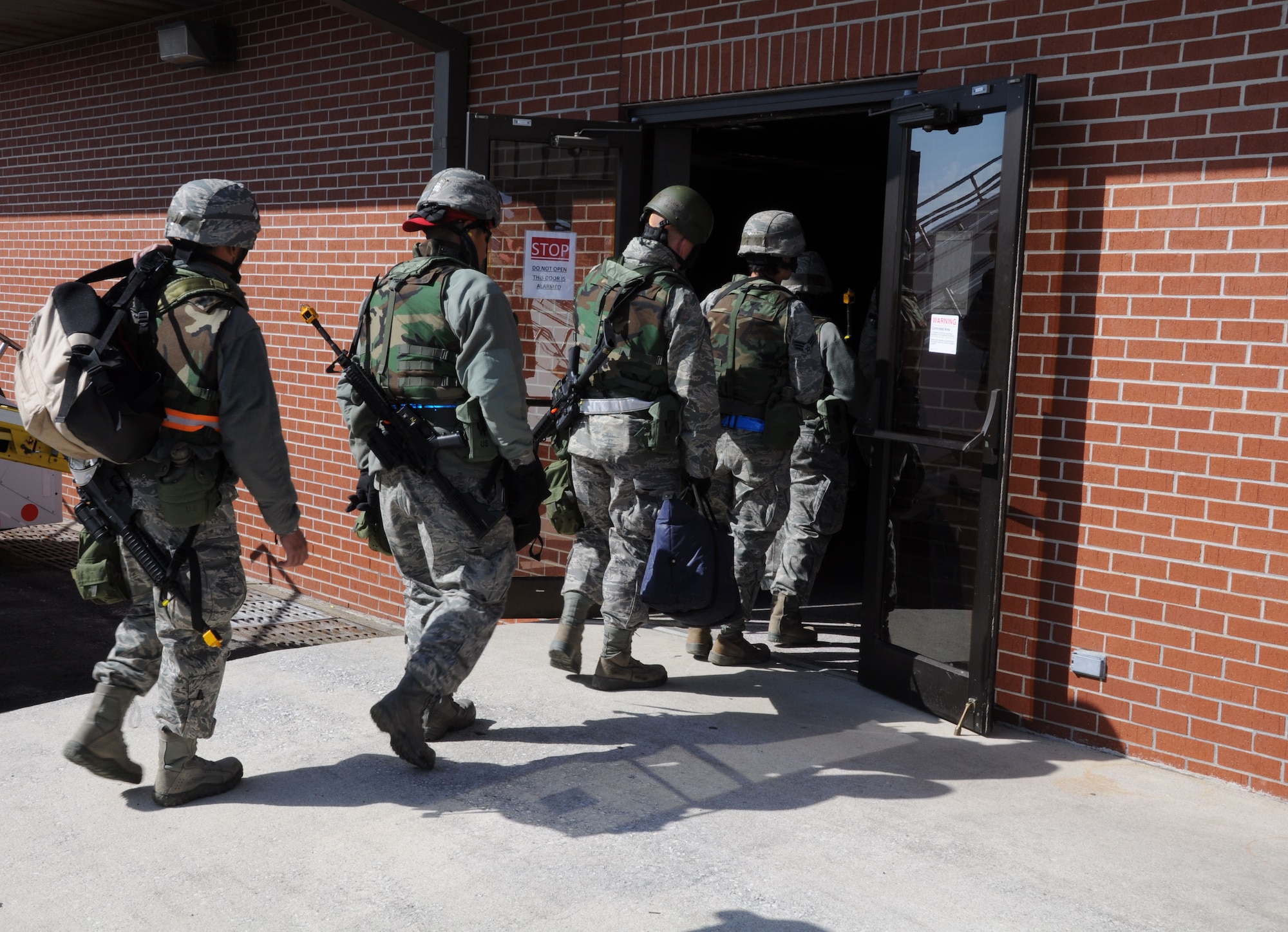 Airmen from the 560th Red Horse Squadron enter the passenger terminal March 11, 2012 at Joint Base Charleston, S.C. after completing a four day operational readiness exercise at the North Carolina Air National Guard’s 145th Regional Training Site in New London, N.C. The exercise gave Charleston Airmen the opportunity to utilize their airbase readiness skills and prepared them for potential real world events and deployments. (U.S. Air Force photo/Staff Sgt. Shane Ellis)