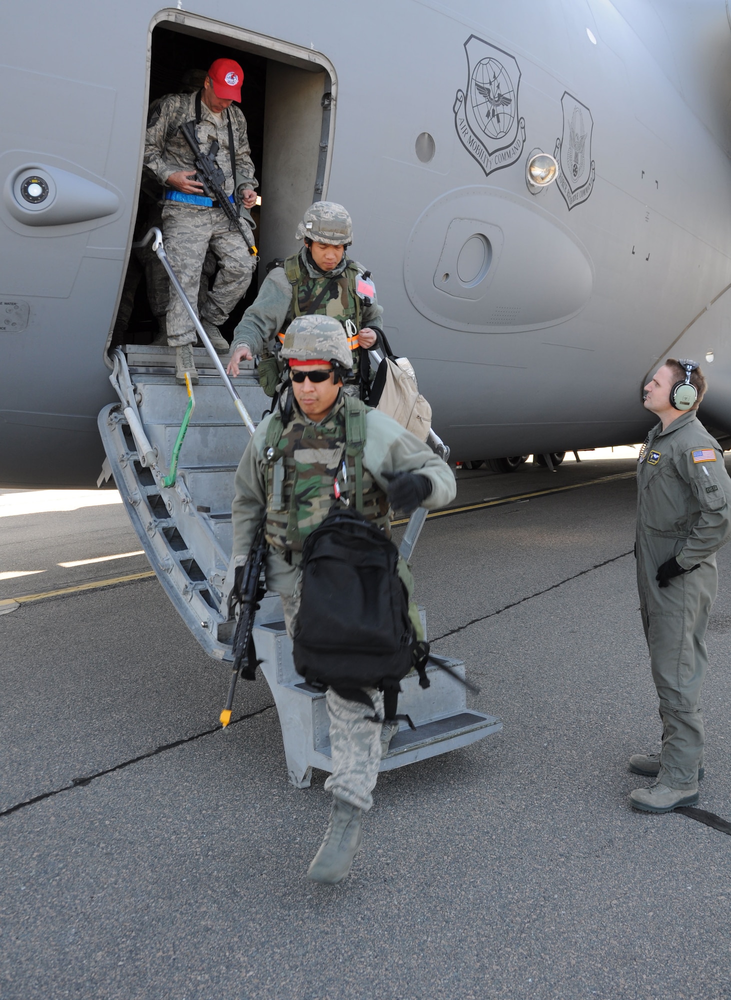 Airmen from the 560th Red Horse Squadron exit a C-17 Globemaster III March 11, 2012 at Joint Base Charleston, S.C. after completing a four day operational readiness exercise at the North Carolina Air National Guard’s 145th Regional Training Site in New London, N.C. The exercise gave Charleston Airmen the opportunity to utilize their airbase readiness skills and prepared them for potential real world events and deployments. (U.S. Air Force photo/Staff Sgt. Shane Ellis)