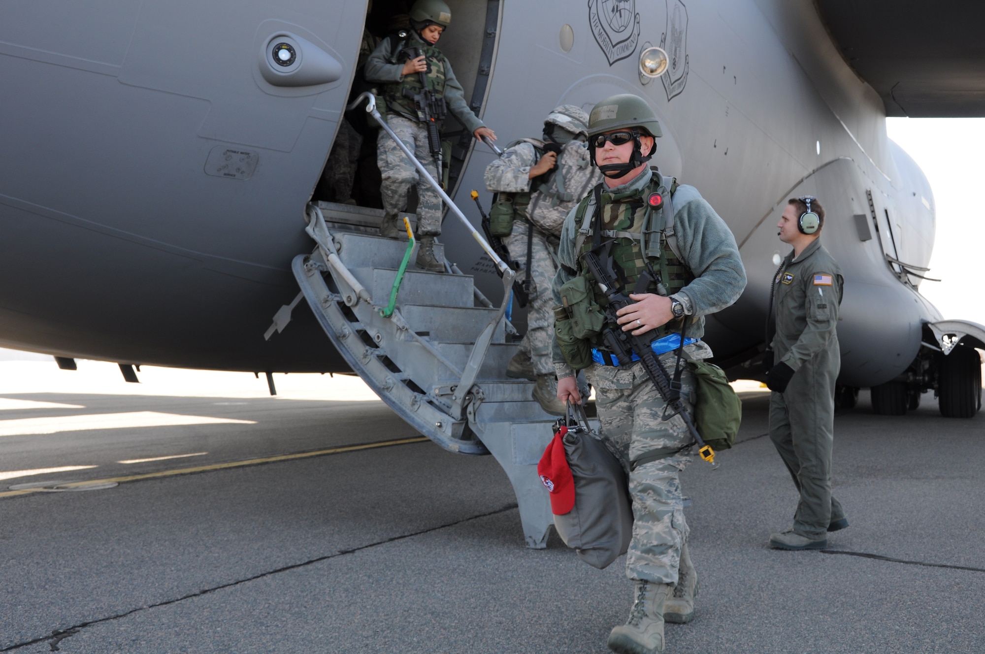 Airmen from the 560th Red Horse Squadron exit a C-17 Globemaster III March 11, 2012 at Joint Base Charleston, S.C. after completing a four day operational readiness exercise at the North Carolina Air National Guard’s 145th Regional Training Site in New London, N.C. The exercise gave Charleston Airmen the opportunity to utilize their airbase readiness skills and prepared them for potential real world events and deployments. (U.S. Air Force photo/Staff Sgt. Shane Ellis)