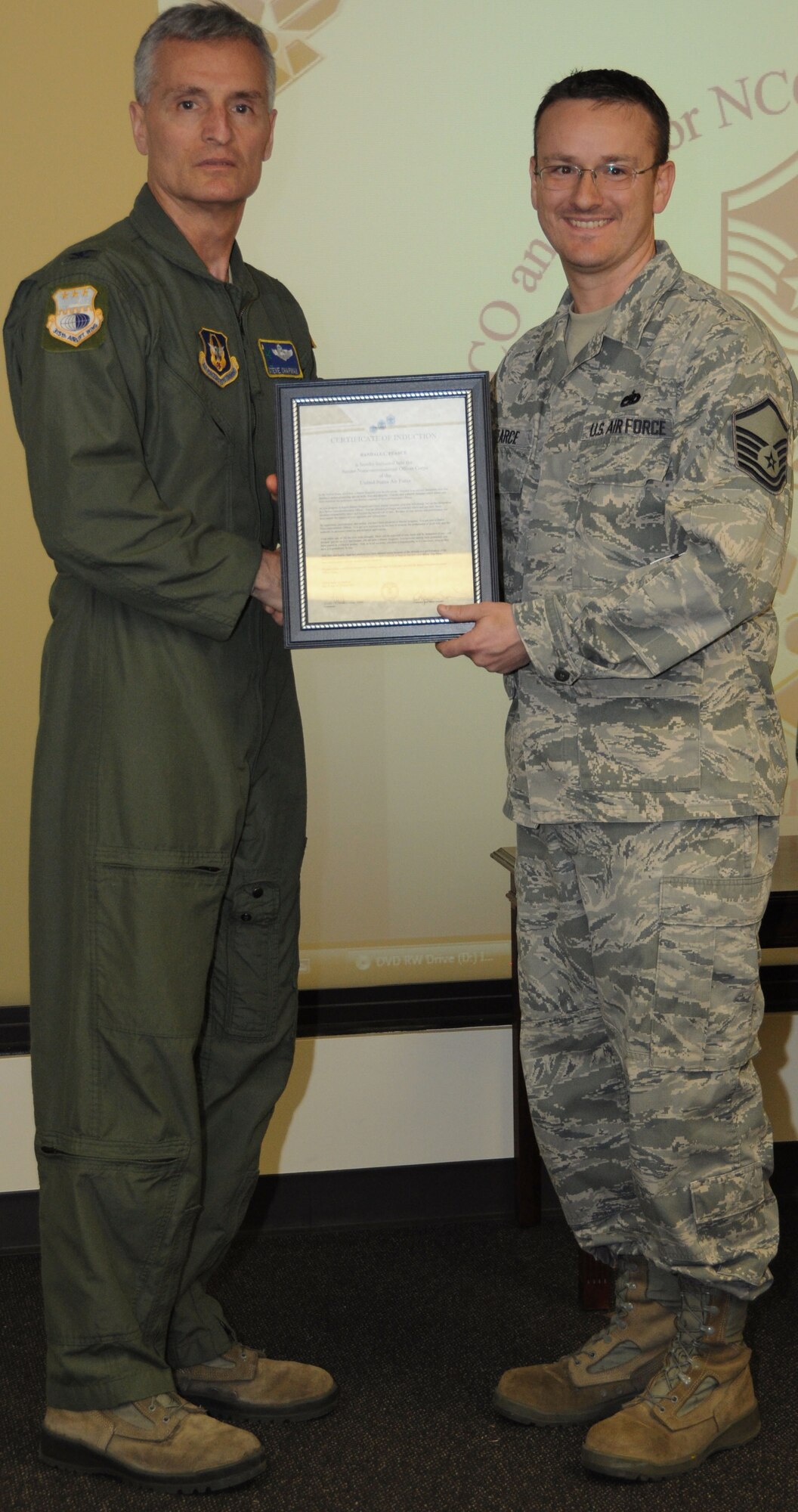 Col, Steven Chapman 315th Airift Wing Commander and Command Chief Master Sergeant Gigi Manning presided over the NCO and SNCO induction ceremony here March 10. MSgt Randal Pearce recieved a coin from Command Chief Manning and a certificate from Col. Chapman. (U.S. Air Force Photo/SrA Bobby Pilch)