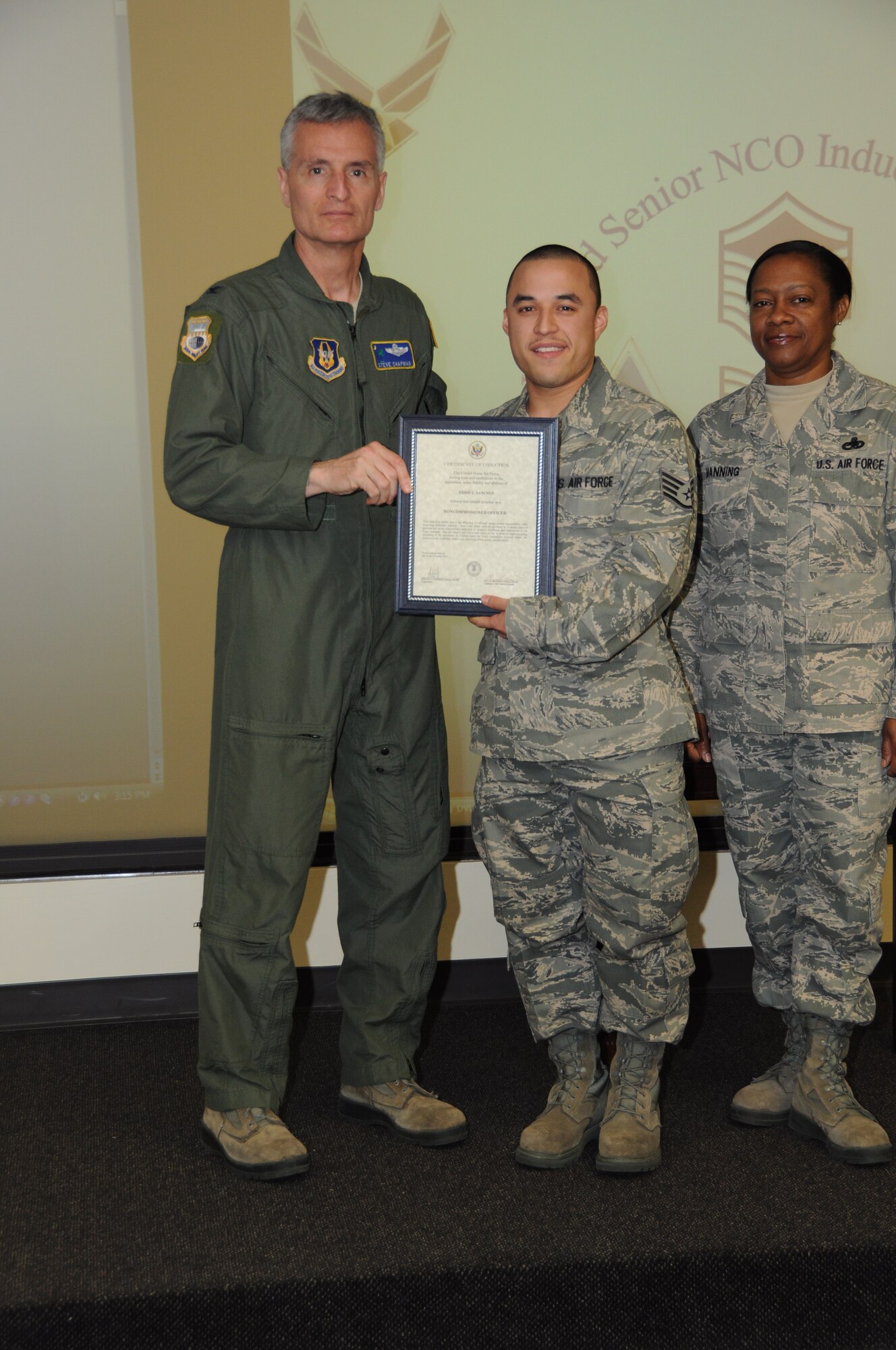 Col, Steven Chapman 315th Airift Wing Commander and Command Chief Master Sergeant Gigi Manning presided over the NCO and SNCO induction ceremony here March 10. SSgt Eddie Sanchez recieved a coin from Command Chief Manning and a certificate from Col. Chapman. (U.S. Air Force Photo/SrA Bobby Pilch)